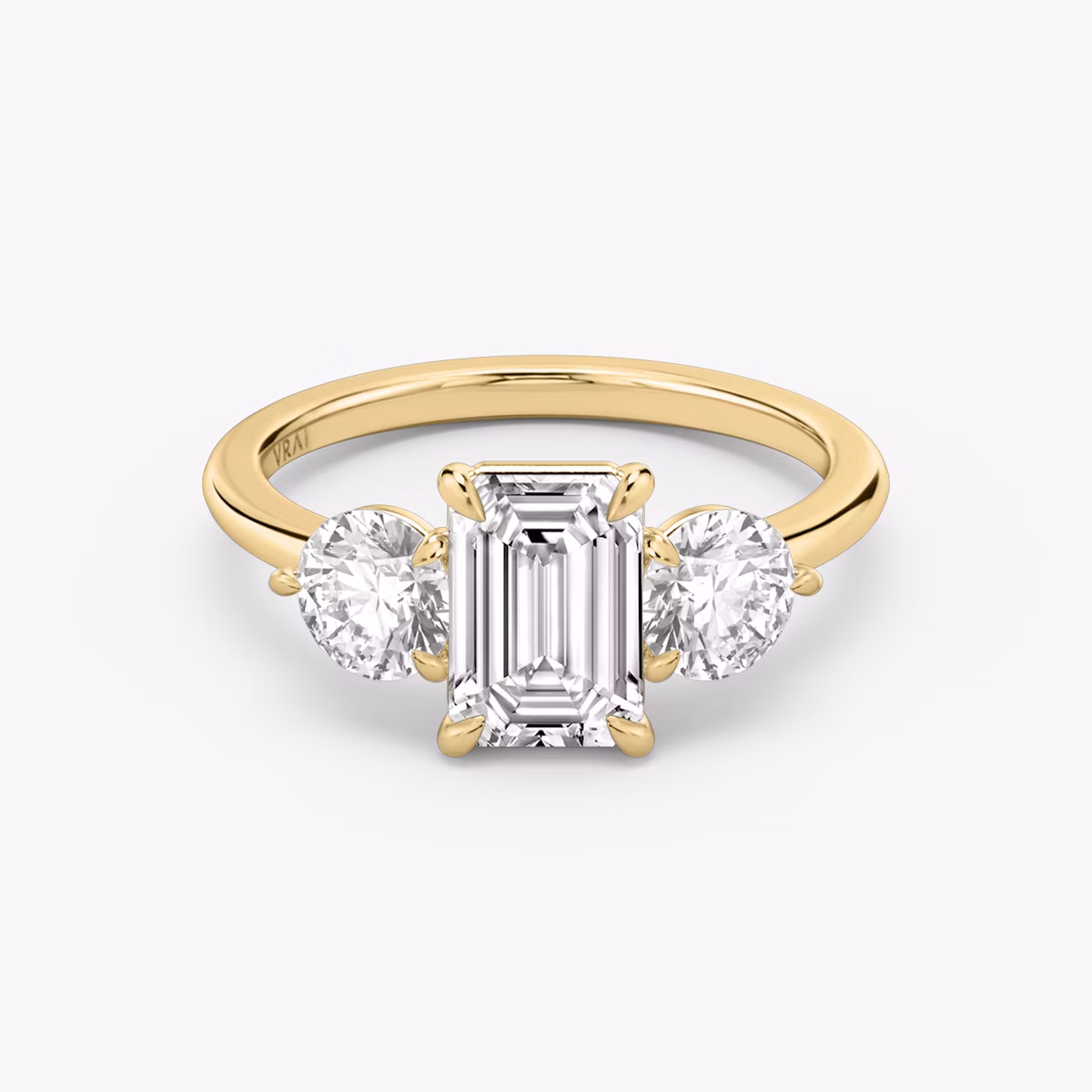The Three Stone | Emerald | 18k | Yellow Gold | bandAccent: Plain | sideStoneCarat: 0.50ct | sideStoneShape: Round Brilliant | diamondOrientation: vertical | caratWeight: other