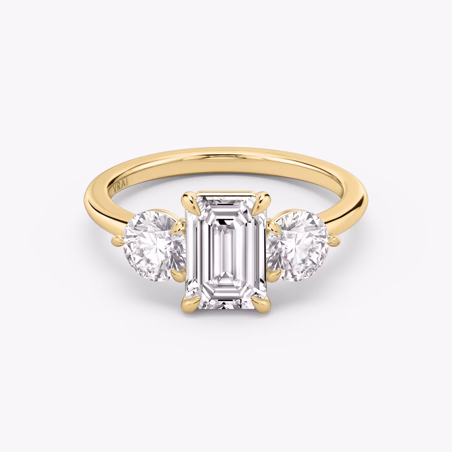 The Three Stone | Emerald | 18k | Yellow Gold | bandAccent: Plain | sideStoneCarat: 0.50ct | sideStoneShape: Round Brilliant | diamondOrientation: vertical | caratWeight: other