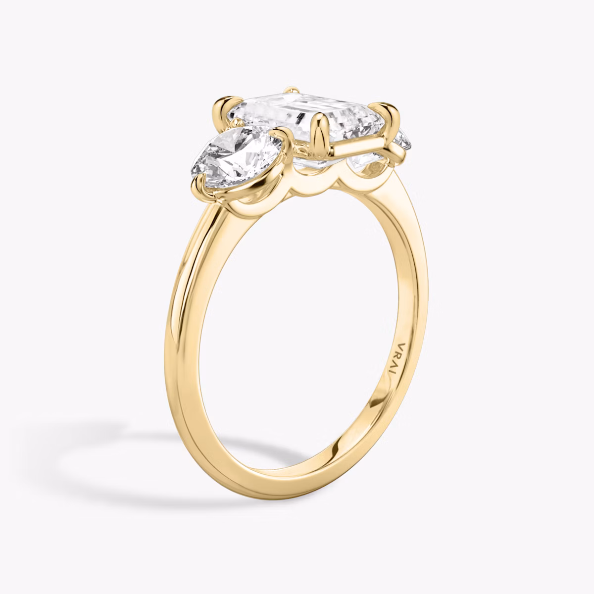 The Three Stone | Emerald | 18k | Yellow Gold | bandAccent: Plain | sideStoneCarat: 0.50ct | sideStoneShape: Round Brilliant | diamondOrientation: vertical | caratWeight: other