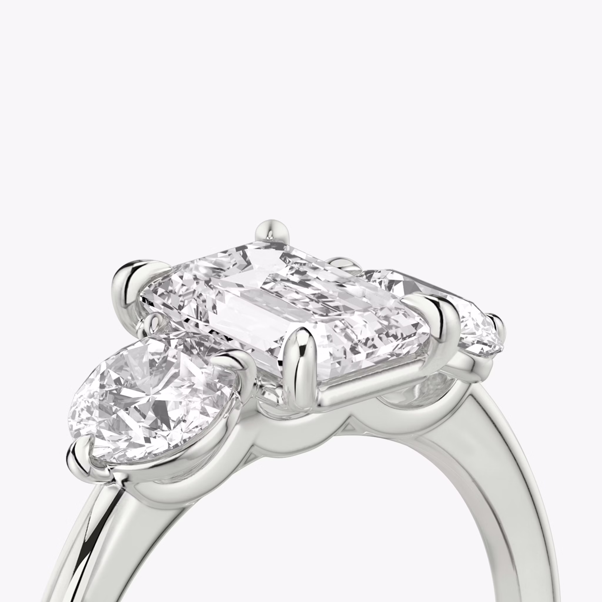 The Three Stone | Emerald | 18k | White Gold | bandAccent: Plain | sideStoneCarat: 0.50ct | sideStoneShape: Round Brilliant | diamondOrientation: vertical | caratWeight: other