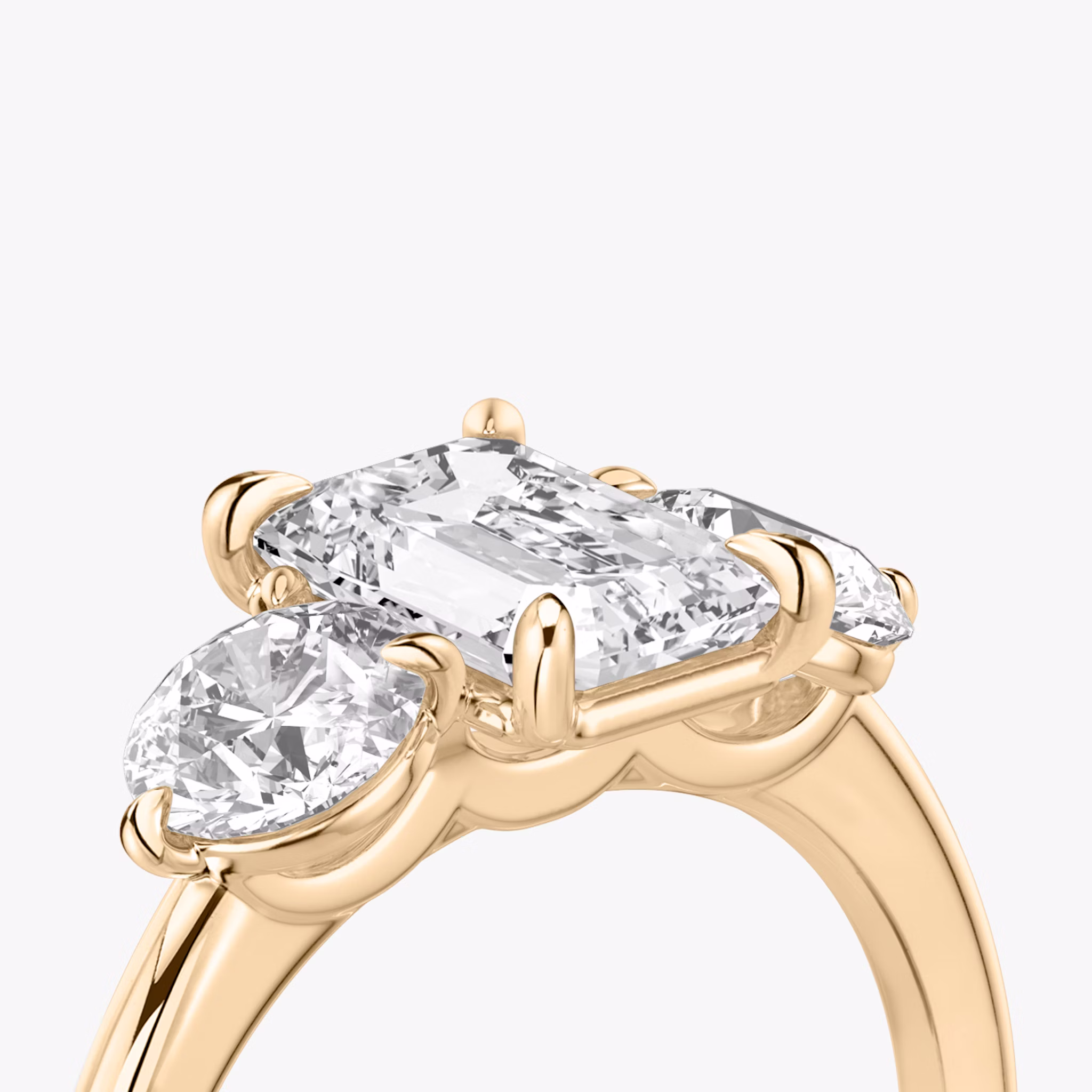 The Three Stone | Emerald | 14k | Rose Gold | bandAccent: Plain | sideStoneCarat: 0.50ct | sideStoneShape: Round Brilliant | diamondOrientation: vertical | caratWeight: other