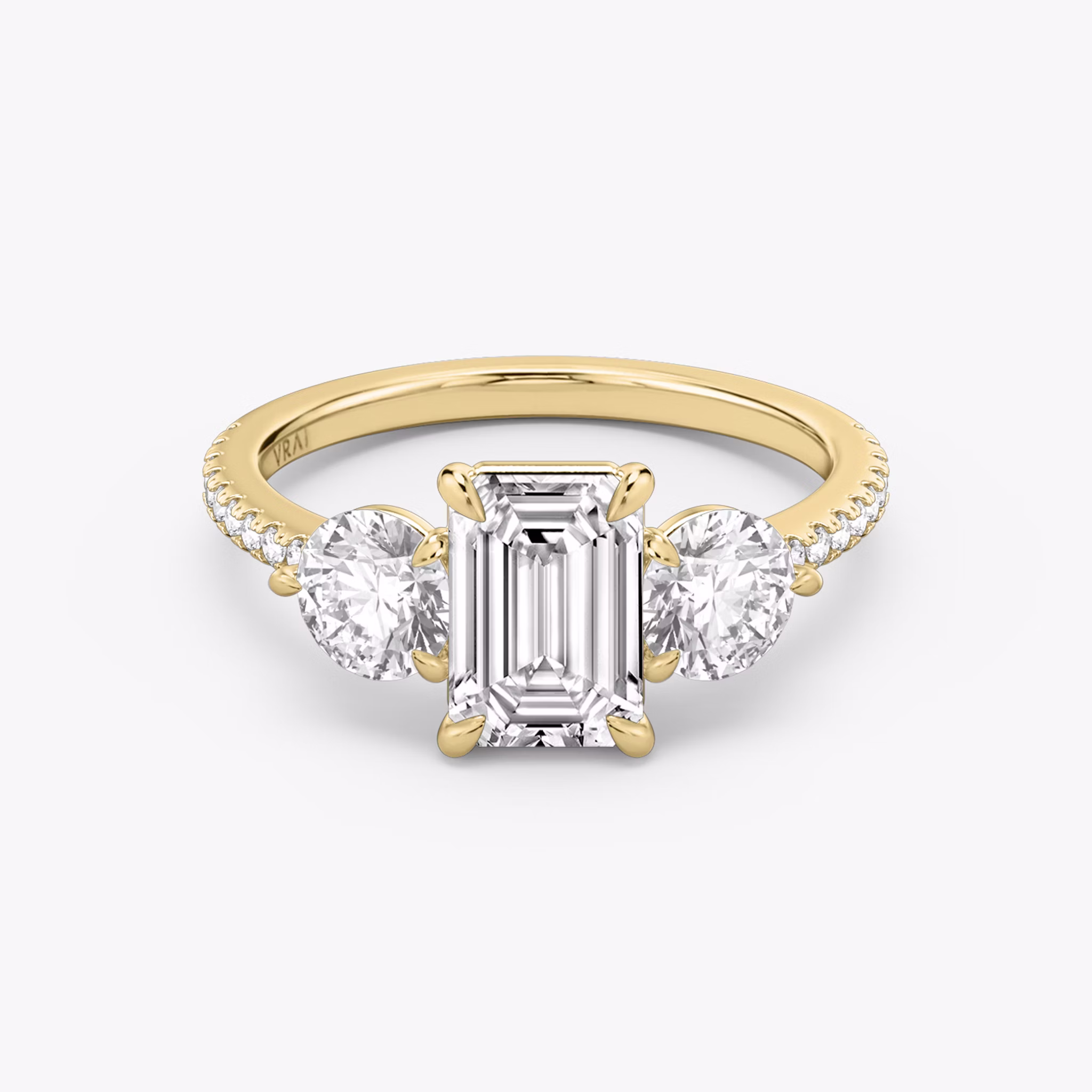 The Three Stone | Emerald | 18k | Yellow Gold | bandAccent: Pavé | sideStoneCarat: 0.50ct | sideStoneShape: Round Brilliant | diamondOrientation: vertical | caratWeight: other