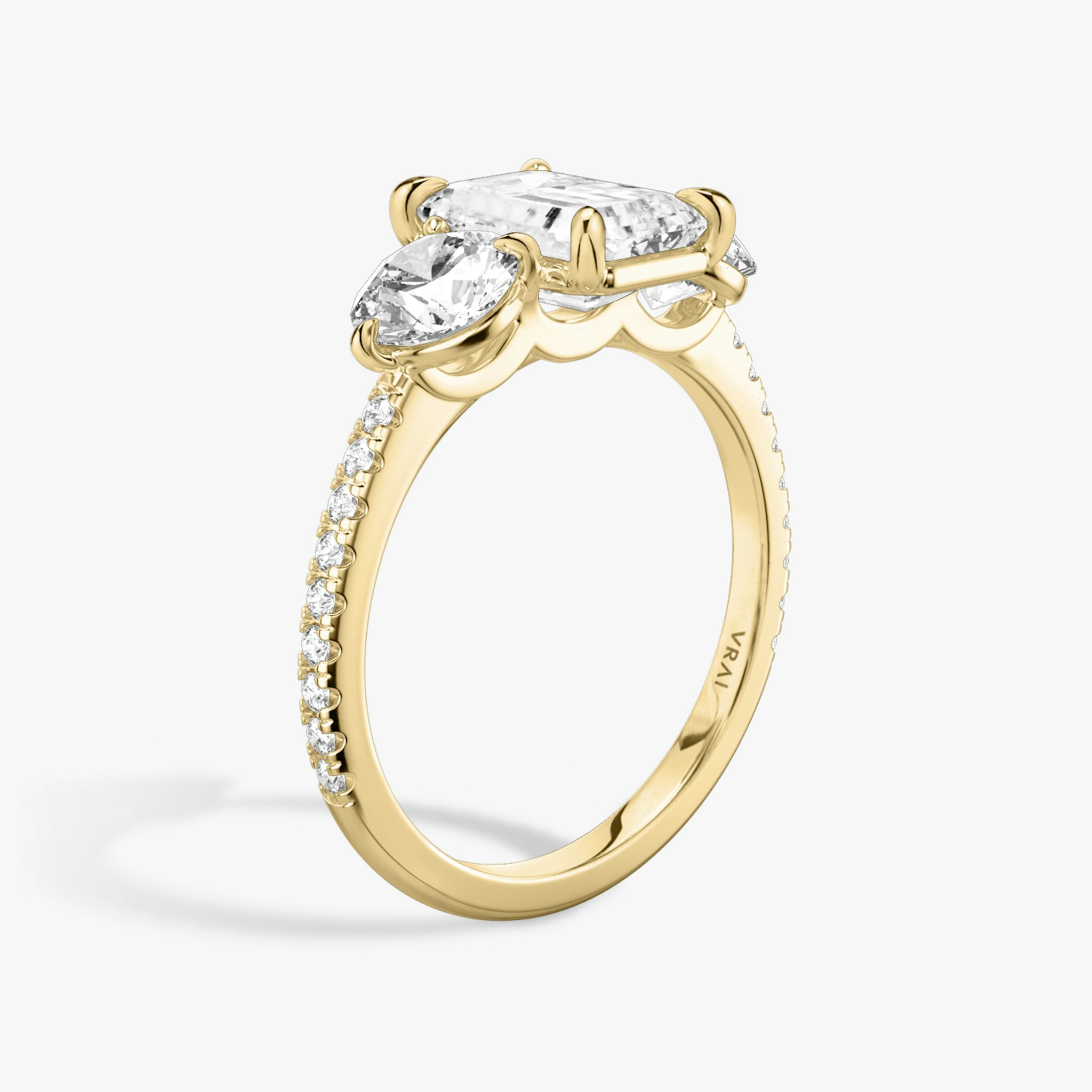 The Three Stone | Emerald | 18k | Yellow Gold | bandAccent: Pavé | sideStoneCarat: 0.50ct | sideStoneShape: Round Brilliant | diamondOrientation: vertical | caratWeight: other