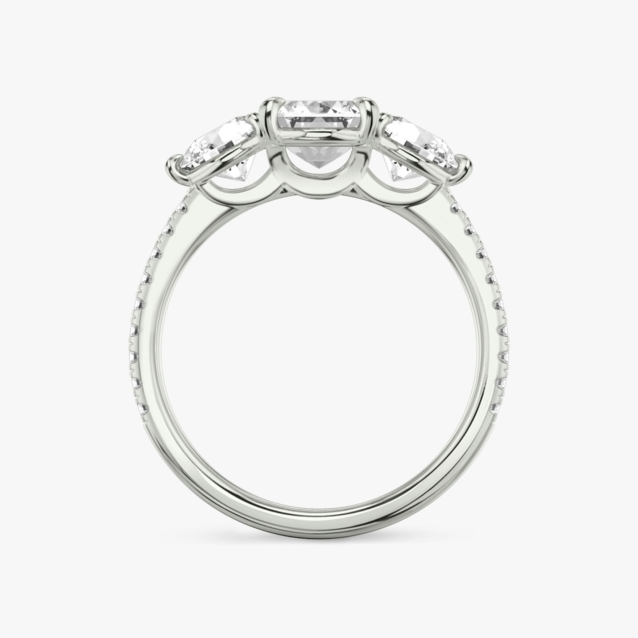 The Three Stone | Emerald | 18k | White Gold | bandAccent: Pavé | sideStoneCarat: 0.50ct | sideStoneShape: Round Brilliant | diamondOrientation: vertical | caratWeight: other