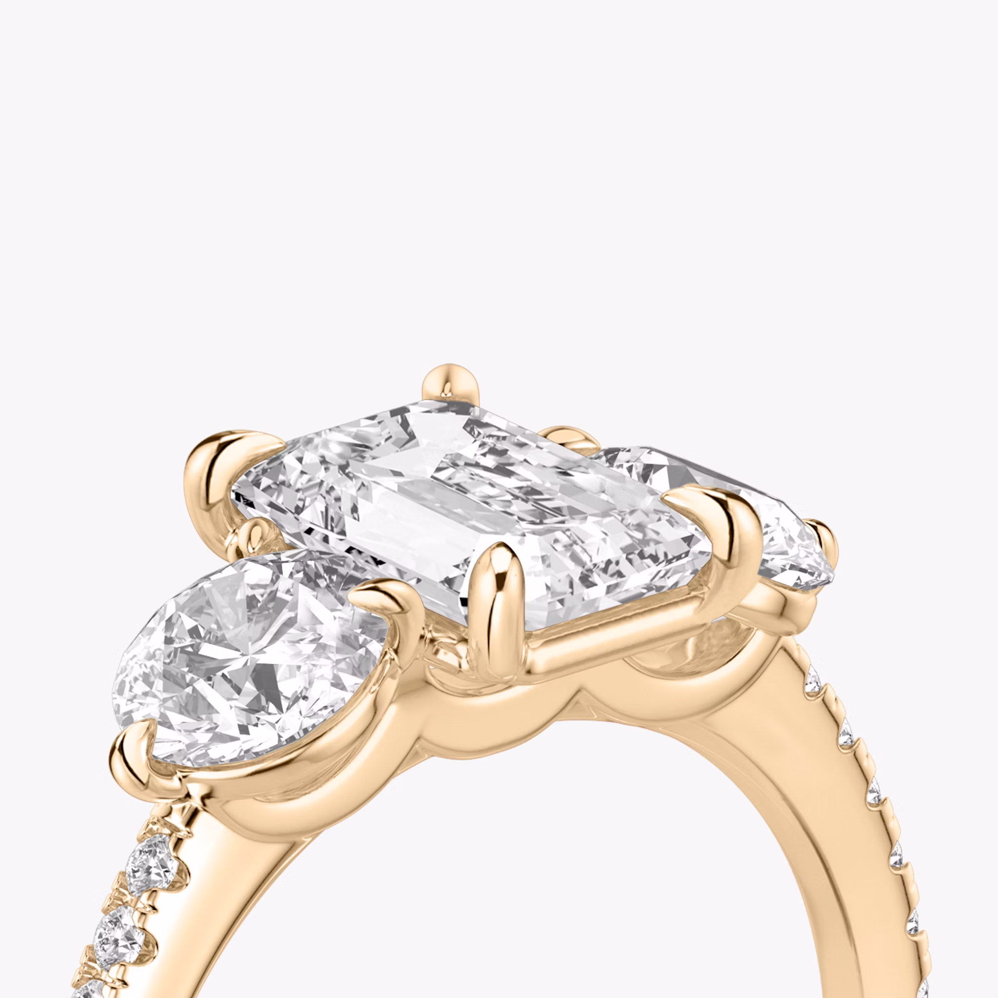 The Three Stone | Emerald | 14k | Rose Gold | bandAccent: Pavé | sideStoneCarat: 0.50ct | sideStoneShape: Round Brilliant | diamondOrientation: vertical | caratWeight: other