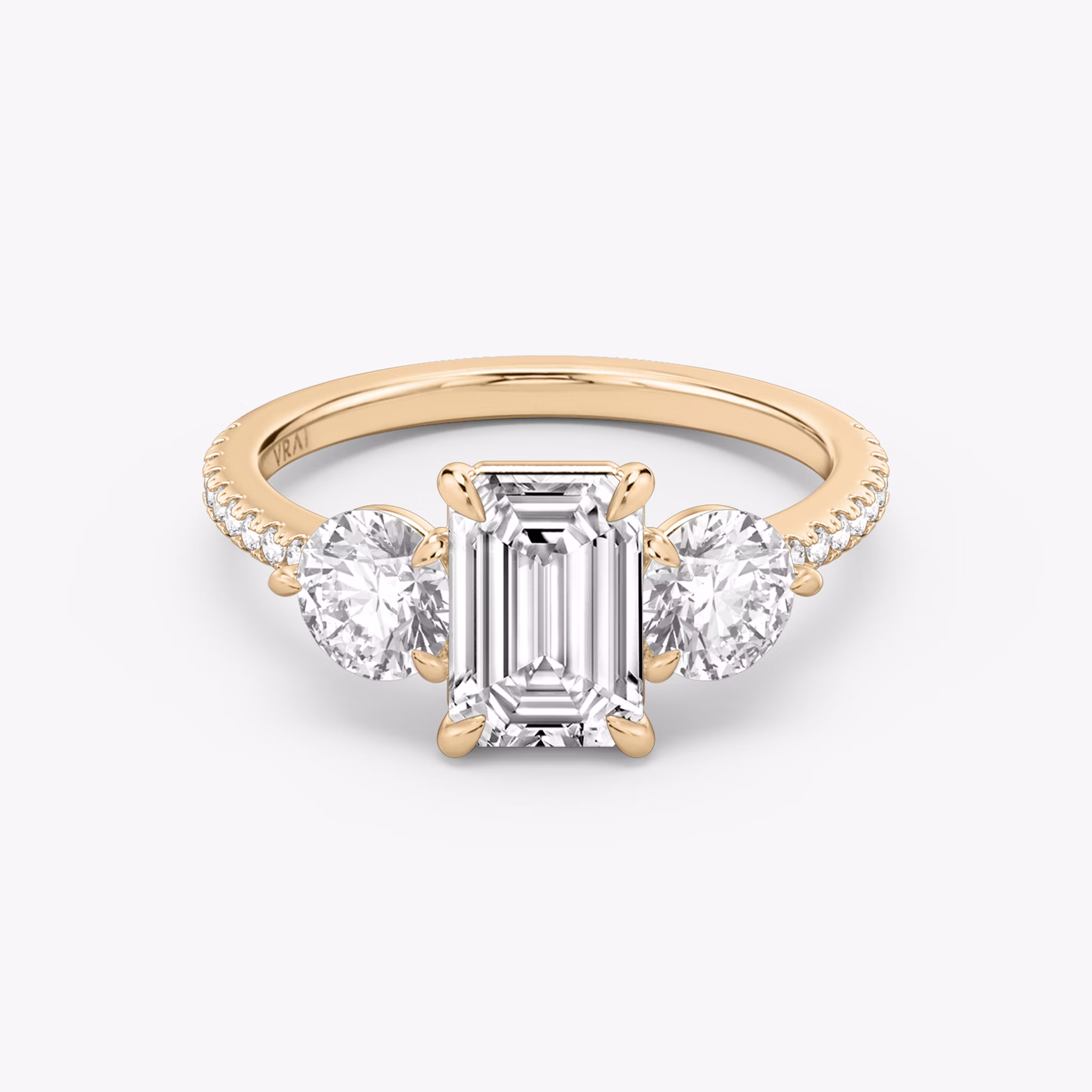 The Three Stone | Emerald | 14k | Rose Gold | bandAccent: Pavé | sideStoneCarat: 0.50ct | sideStoneShape: Round Brilliant | diamondOrientation: vertical | caratWeight: other