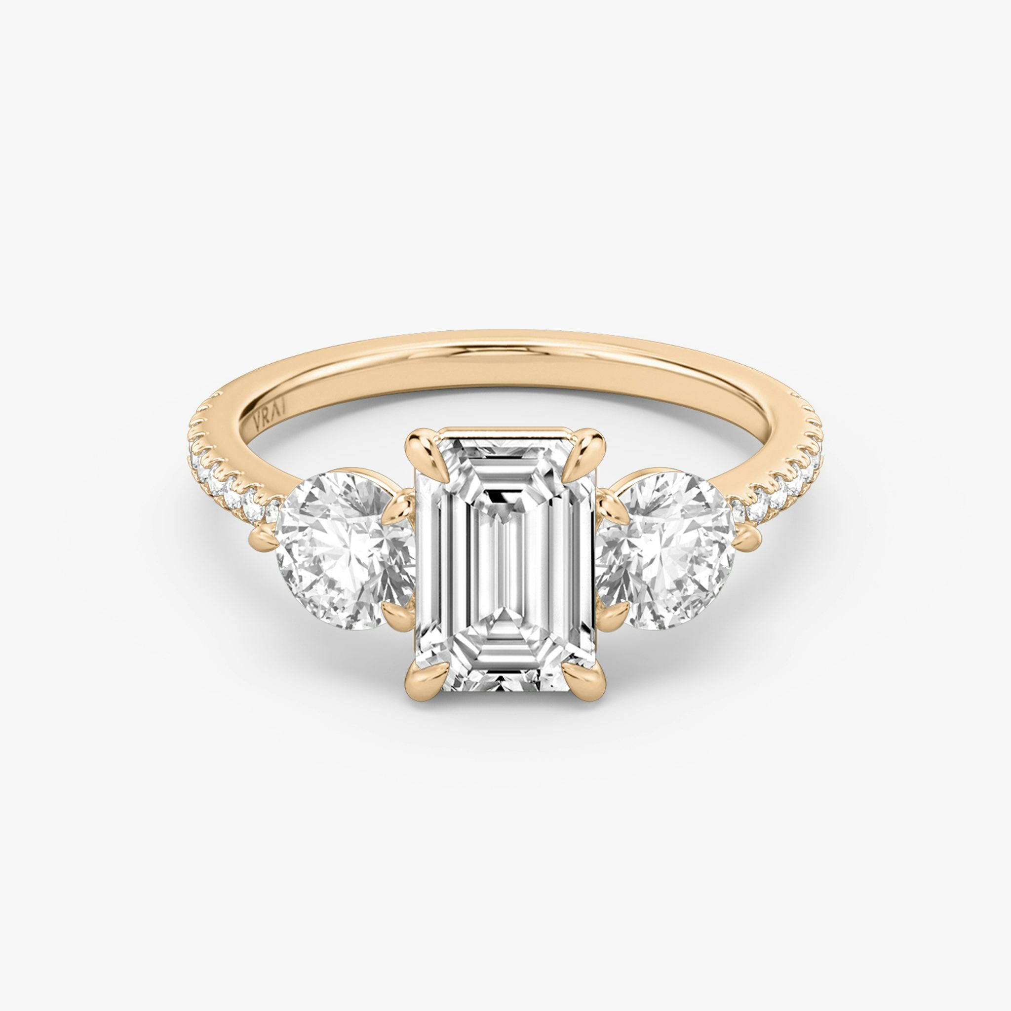 The Three Stone | Emerald | 14k | Rose Gold | bandAccent: Pavé | sideStoneCarat: 0.50ct | sideStoneShape: Round Brilliant | diamondOrientation: vertical | caratWeight: other