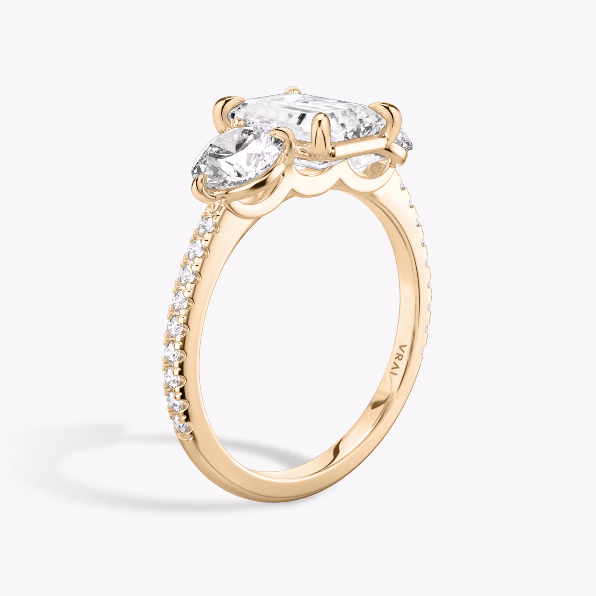 The Three Stone | Emerald | 14k | Rose Gold | bandAccent: Pavé | sideStoneCarat: 0.50ct | sideStoneShape: Round Brilliant | diamondOrientation: vertical | caratWeight: other