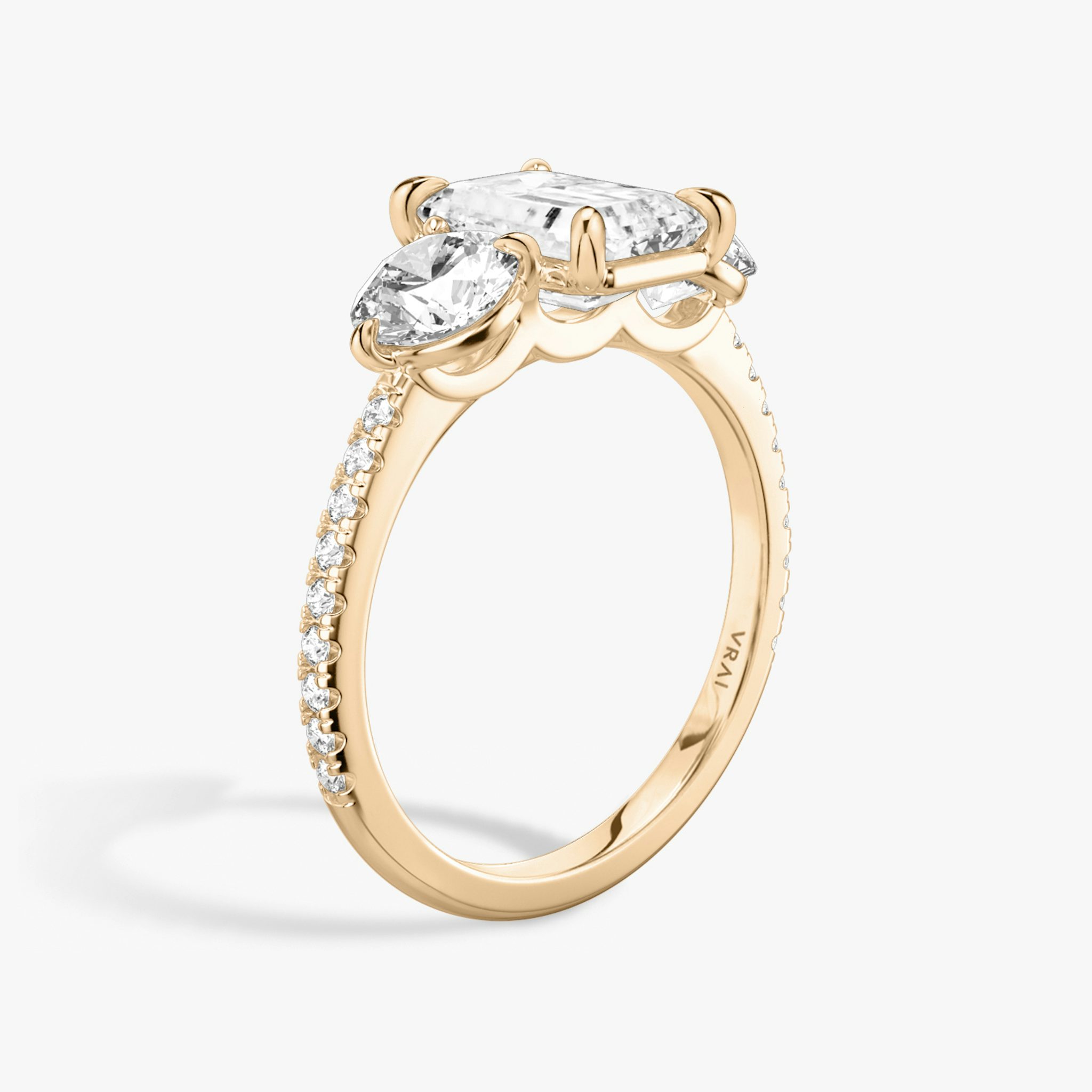 The Three Stone | Emerald | 14k | Rose Gold | bandAccent: Pavé | sideStoneCarat: 0.50ct | sideStoneShape: Round Brilliant | diamondOrientation: vertical | caratWeight: other