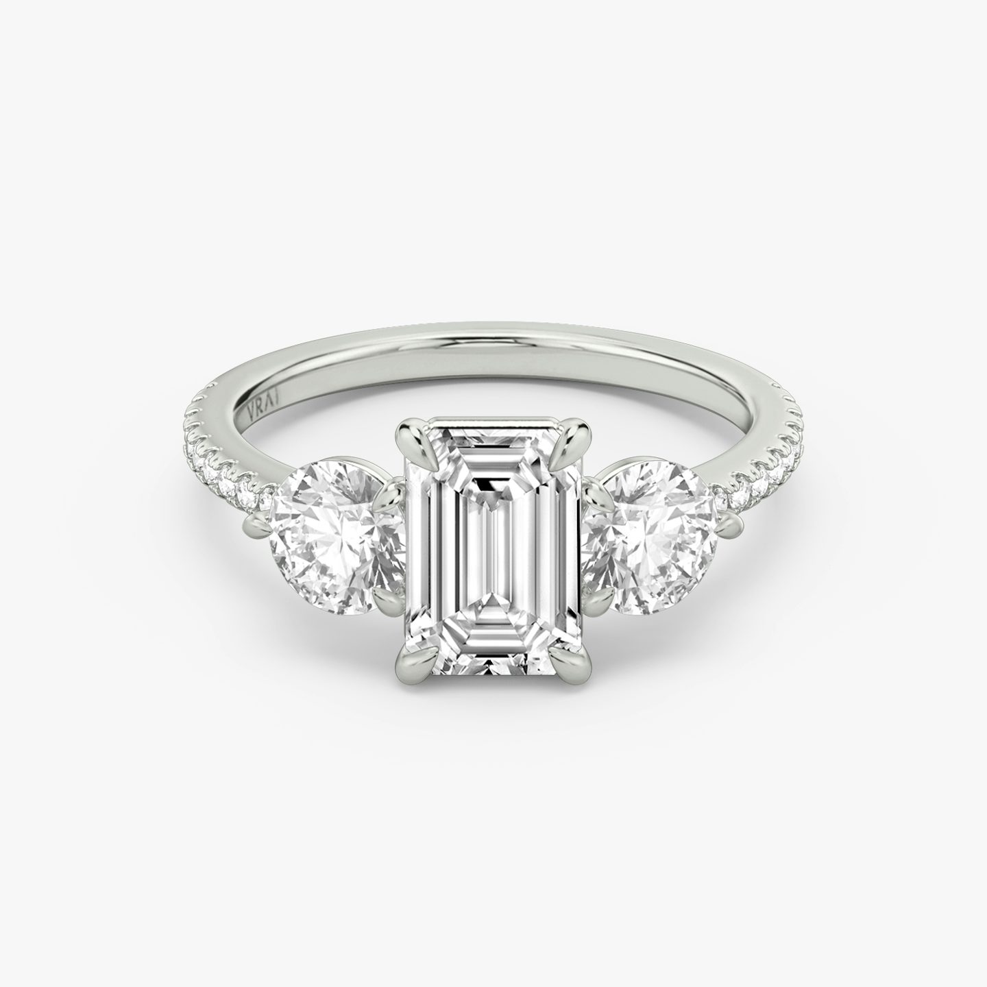 The Three Stone | Emerald | Platinum | bandAccent: Pavé | sideStoneCarat: 0.50ct | sideStoneShape: Round Brilliant | diamondOrientation: vertical | caratWeight: other