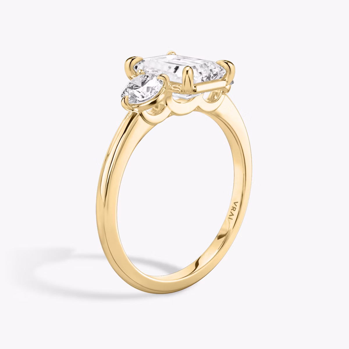 The Three Stone | Emerald | 18k | Yellow Gold | bandAccent: Plain | sideStoneCarat: 0.25ct | sideStoneShape: Round Brilliant | diamondOrientation: vertical | caratWeight: other