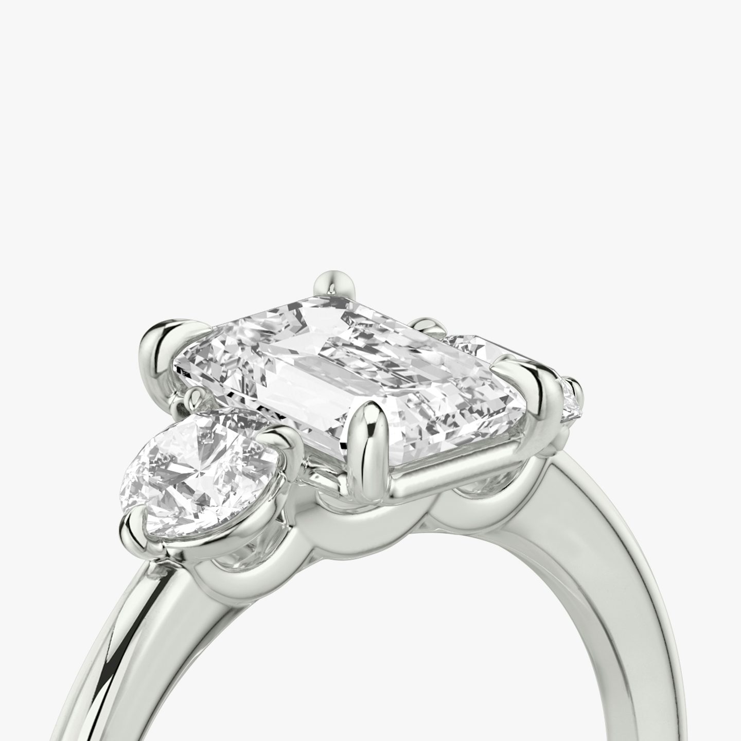 The Three Stone | Emerald | 18k | White Gold | bandAccent: Plain | sideStoneCarat: 0.25ct | sideStoneShape: Round Brilliant | diamondOrientation: vertical | caratWeight: other