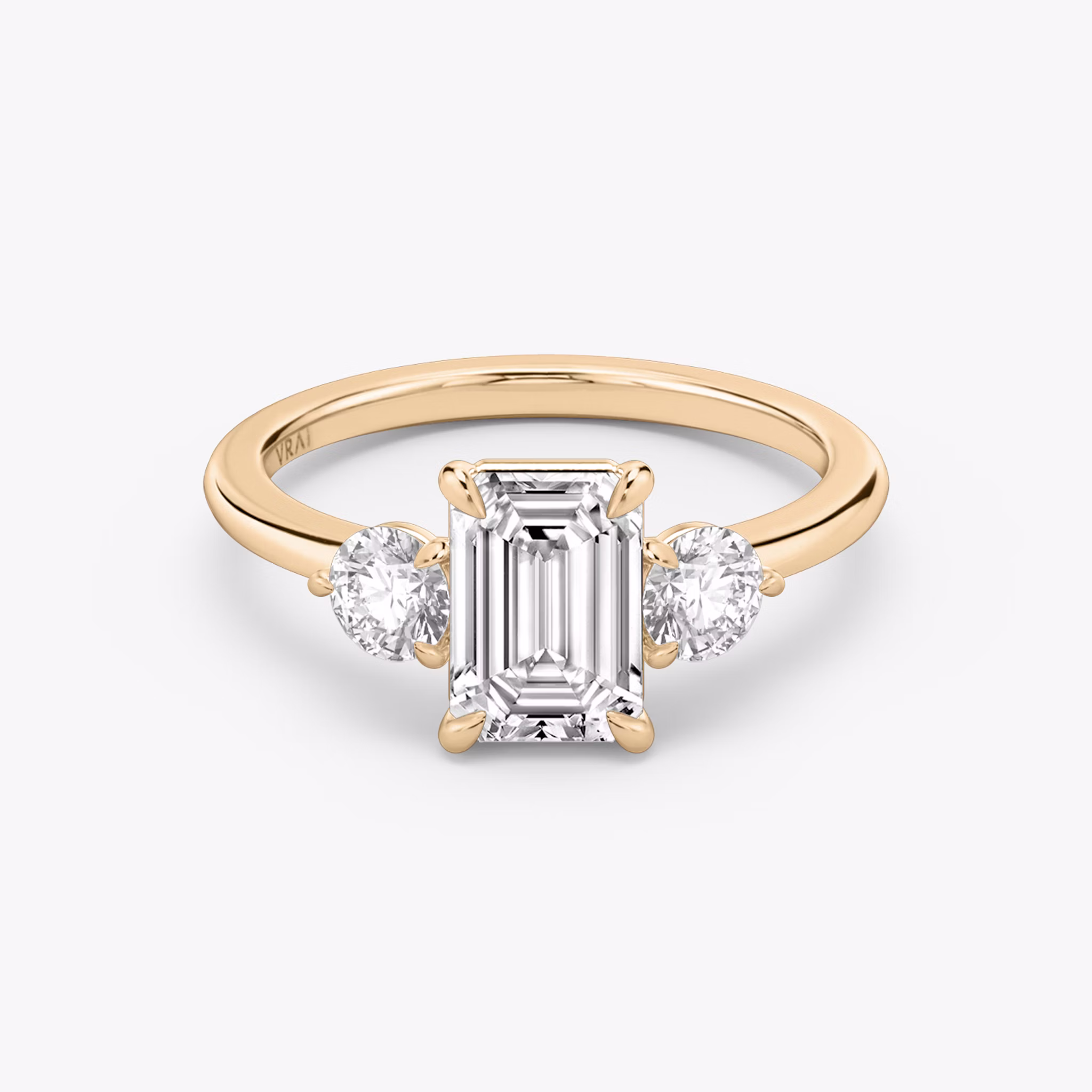The Three Stone | Emerald | 14k | Rose Gold | bandAccent: Plain | sideStoneCarat: 0.25ct | sideStoneShape: Round Brilliant | diamondOrientation: vertical | caratWeight: other