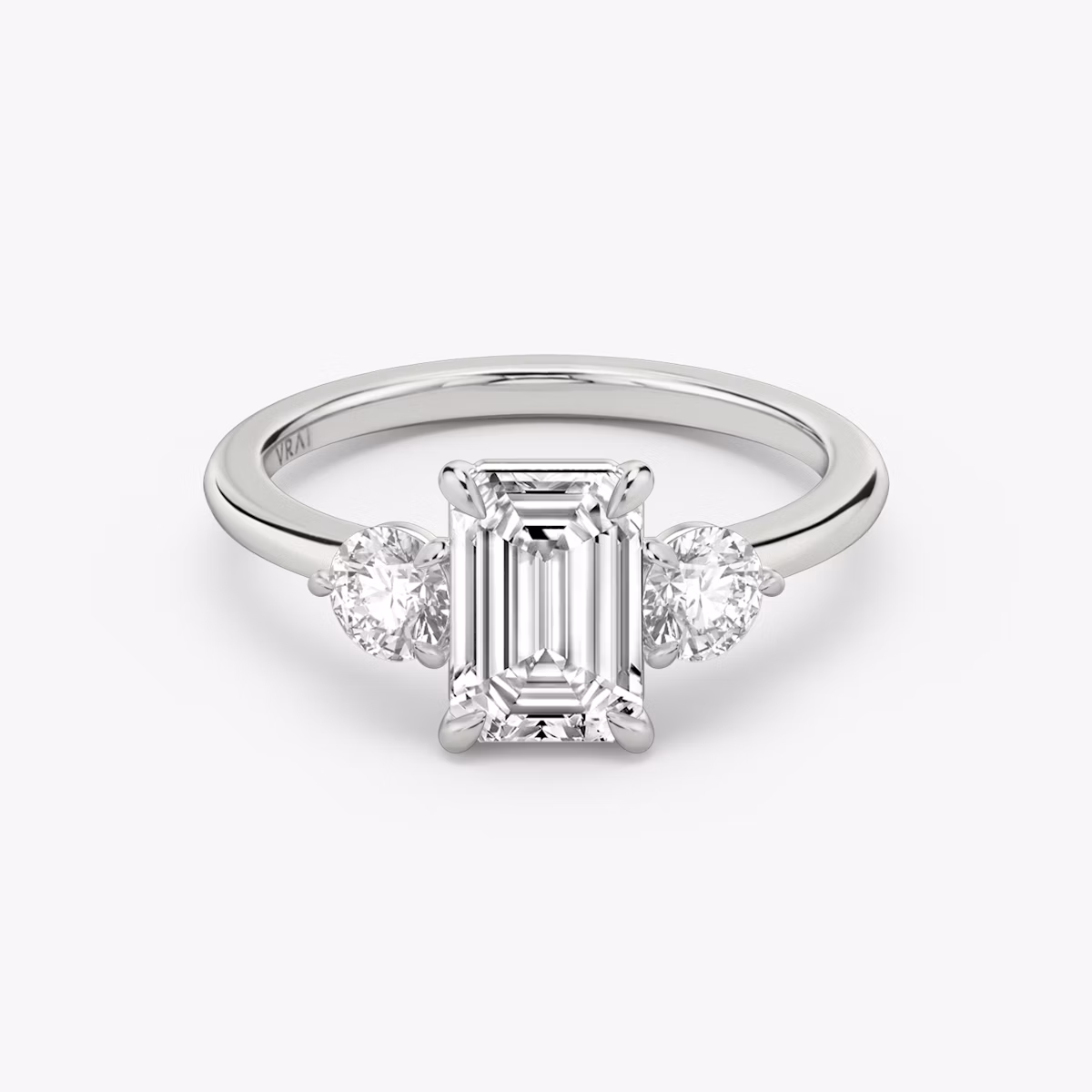 The Three Stone | Emerald | Platinum | bandAccent: Plain | sideStoneCarat: 0.25ct | sideStoneShape: Round Brilliant | diamondOrientation: vertical | caratWeight: other