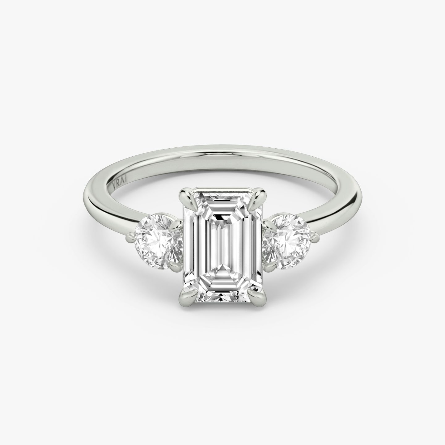The Three Stone | Emerald | Platinum | bandAccent: Plain | sideStoneCarat: 0.25ct | sideStoneShape: Round Brilliant | diamondOrientation: vertical | caratWeight: other