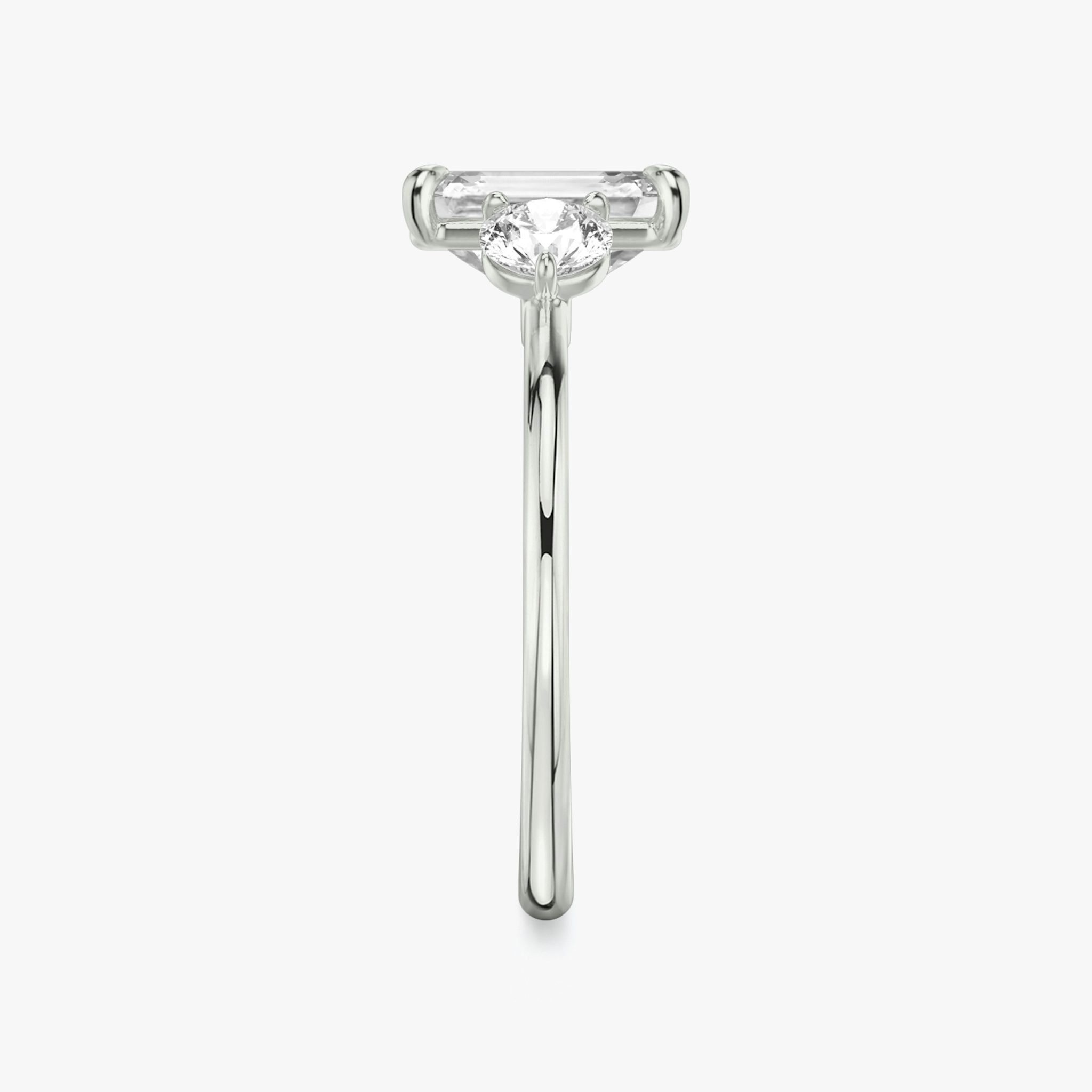 The Three Stone | Emerald | Platinum | bandAccent: Plain | sideStoneCarat: 0.25ct | sideStoneShape: Round Brilliant | diamondOrientation: vertical | caratWeight: other