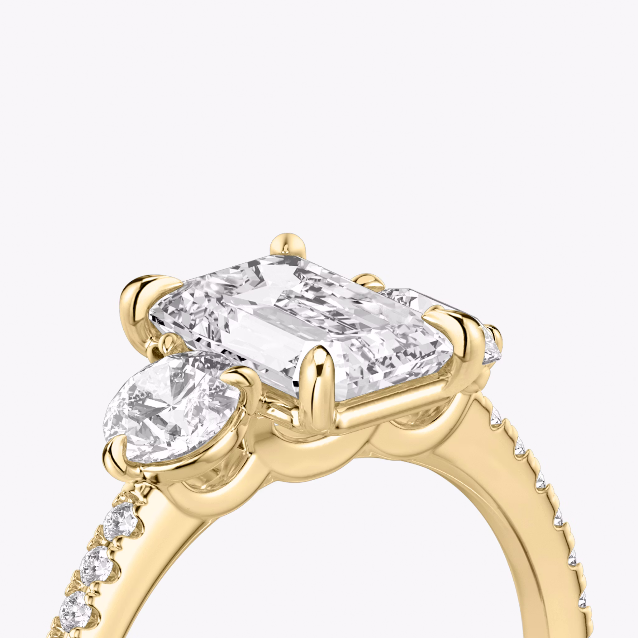 The Three Stone | Emerald | 18k | Yellow Gold | bandAccent: Pavé | sideStoneCarat: 0.25ct | sideStoneShape: Round Brilliant | diamondOrientation: vertical | caratWeight: other