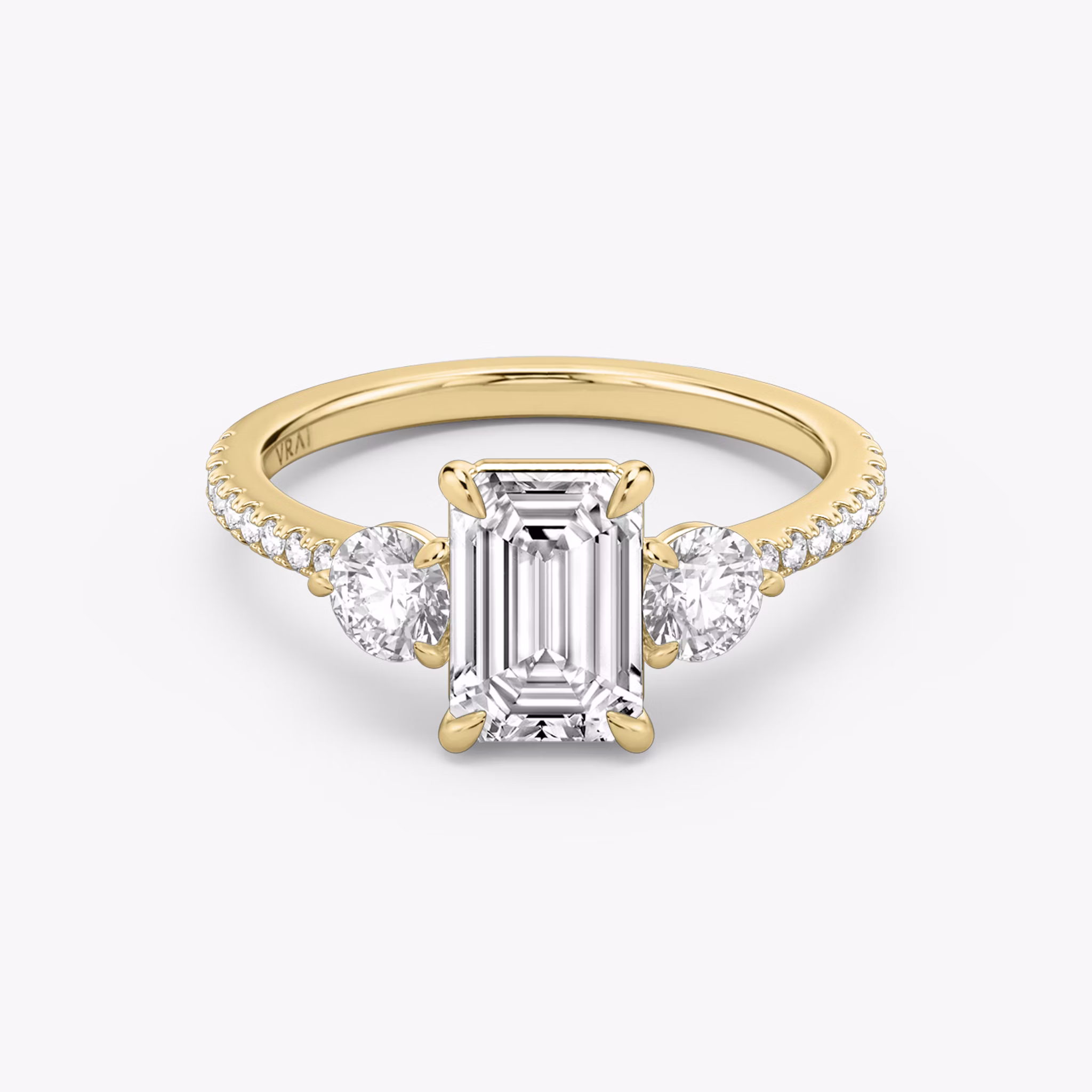 The Three Stone | Emerald | 18k | Yellow Gold | bandAccent: Pavé | sideStoneCarat: 0.25ct | sideStoneShape: Round Brilliant | diamondOrientation: vertical | caratWeight: other