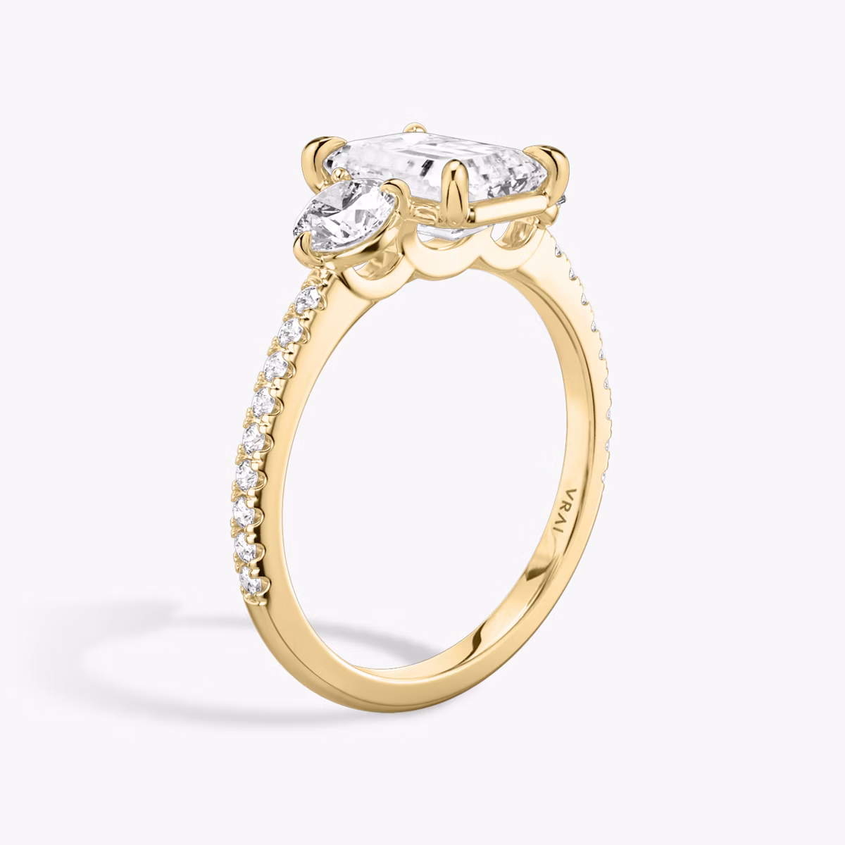 The Three Stone | Emerald | 18k | Yellow Gold | bandAccent: Pavé | sideStoneCarat: 0.25ct | sideStoneShape: Round Brilliant | diamondOrientation: vertical | caratWeight: other