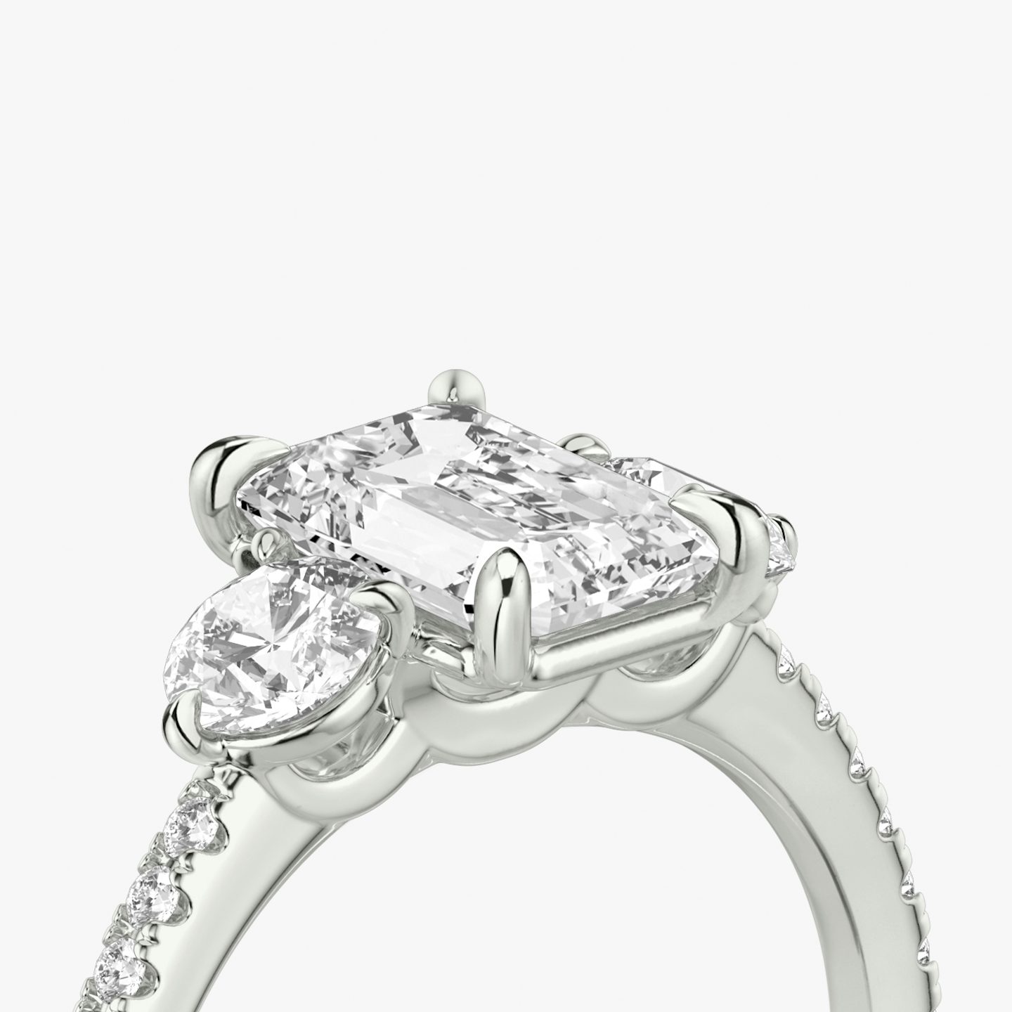 The Three Stone | Emerald | 18k | White Gold | bandAccent: Pavé | sideStoneCarat: 0.25ct | sideStoneShape: Round Brilliant | diamondOrientation: vertical | caratWeight: other