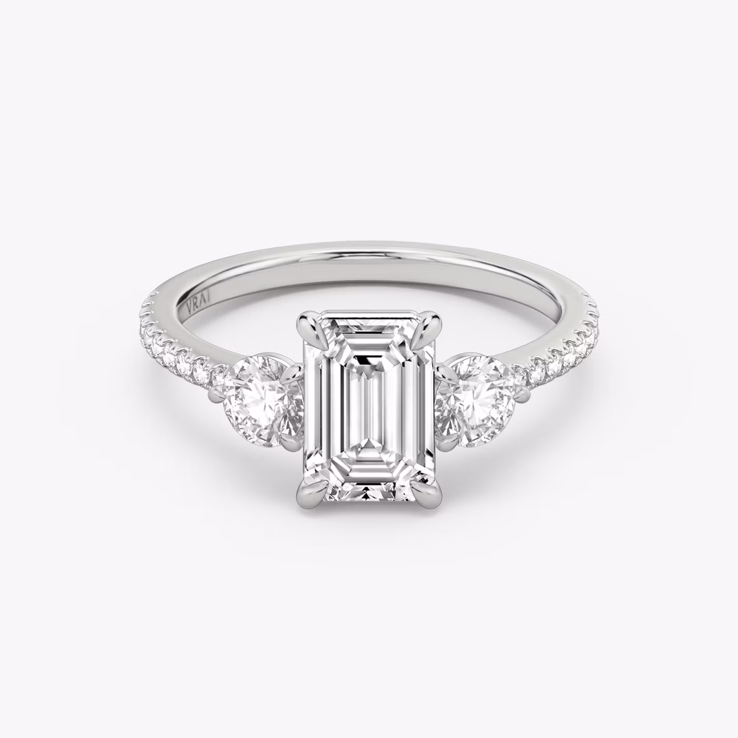 The Three Stone | Emerald | 18k | White Gold | bandAccent: Pavé | sideStoneCarat: 0.25ct | sideStoneShape: Round Brilliant | diamondOrientation: vertical | caratWeight: other