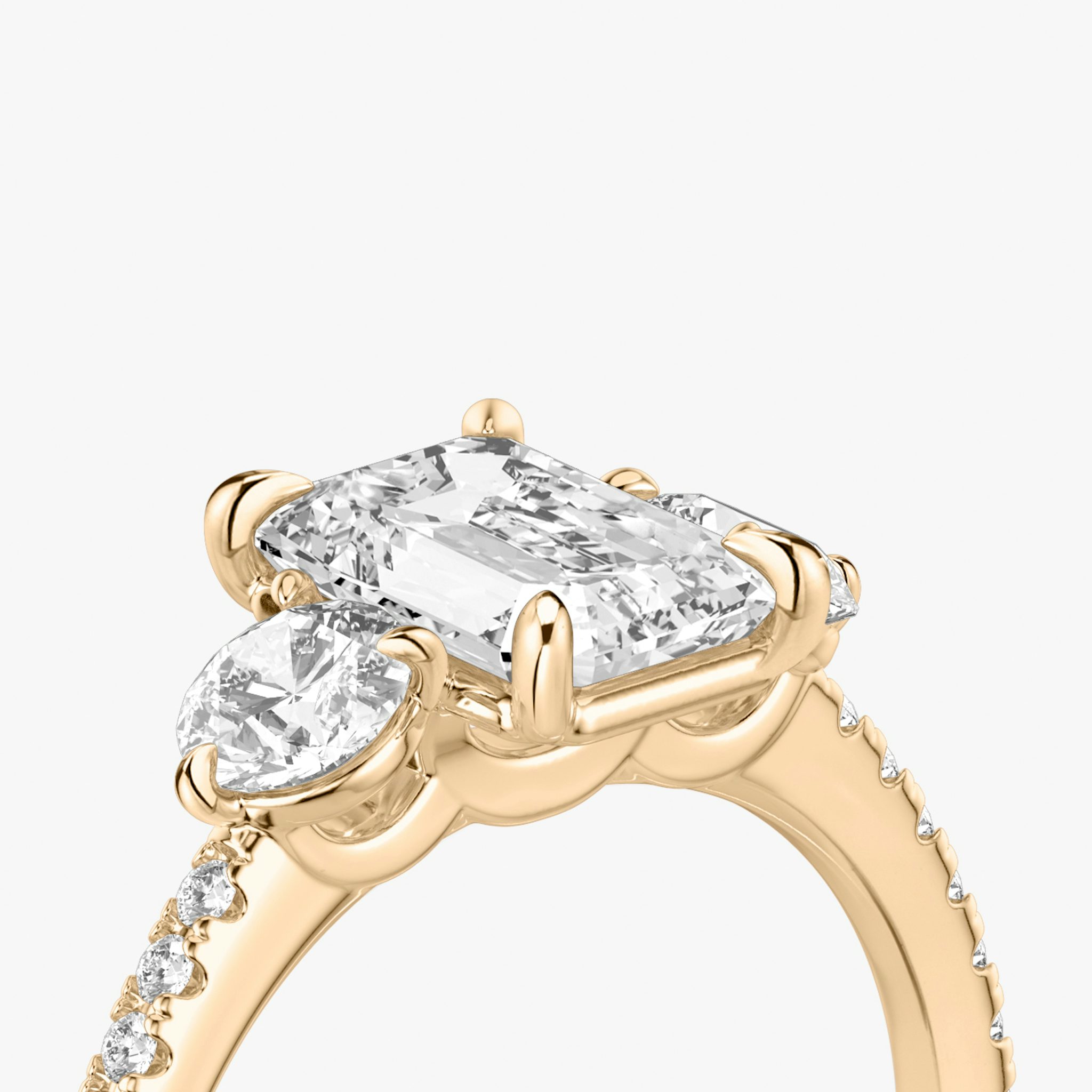 The Three Stone | Emerald | 14k | Rose Gold | bandAccent: Pavé | sideStoneCarat: 0.25ct | sideStoneShape: Round Brilliant | diamondOrientation: vertical | caratWeight: other