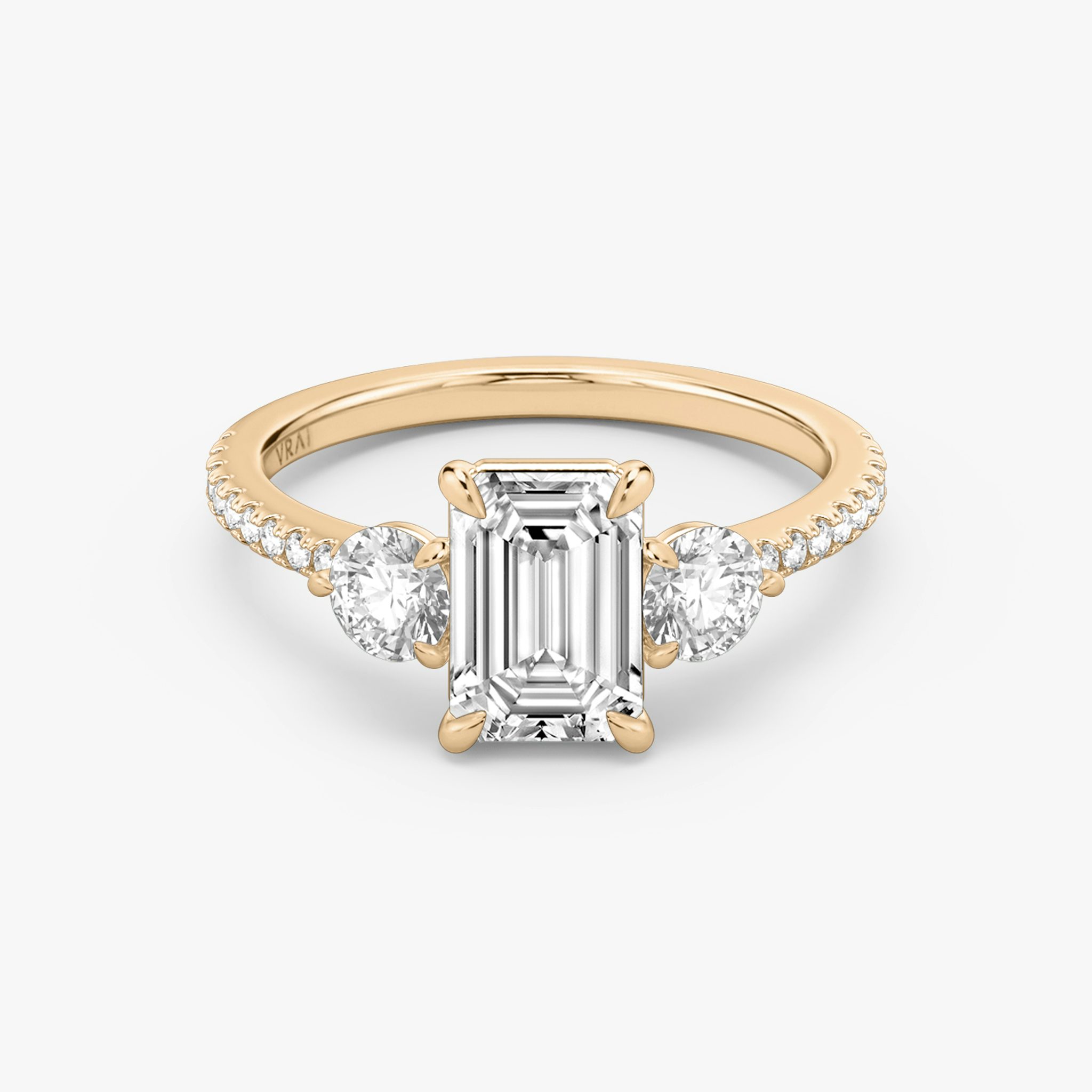 The Three Stone | Emerald | 14k | Rose Gold | bandAccent: Pavé | sideStoneCarat: 0.25ct | sideStoneShape: Round Brilliant | diamondOrientation: vertical | caratWeight: other