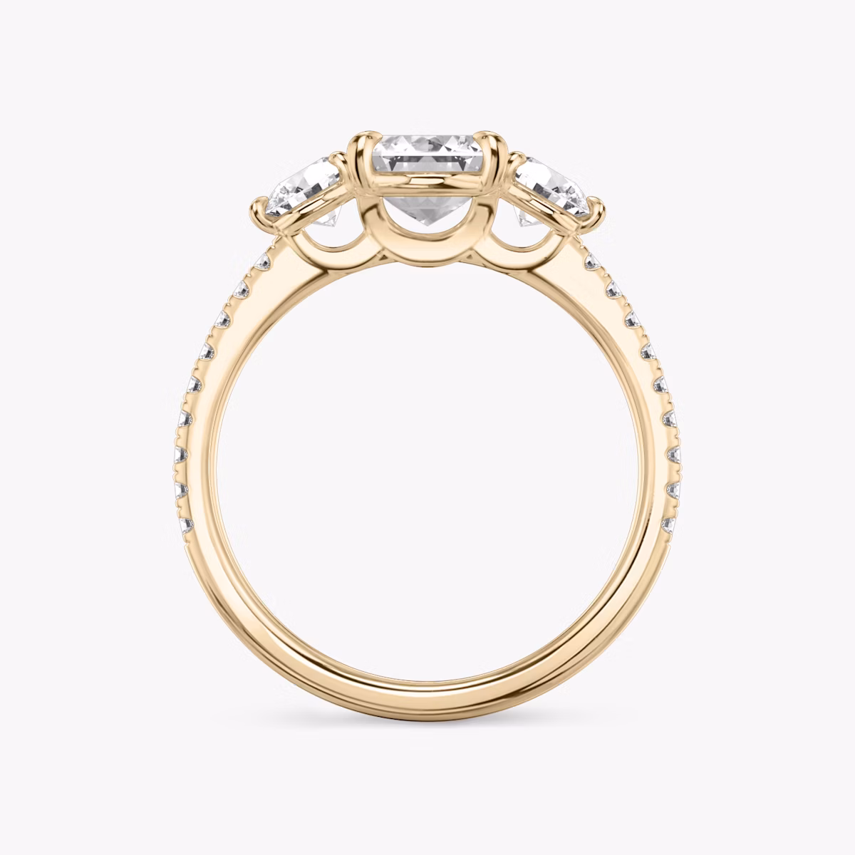 The Three Stone | Emerald | 14k | Rose Gold | bandAccent: Pavé | sideStoneCarat: 0.25ct | sideStoneShape: Round Brilliant | diamondOrientation: vertical | caratWeight: other