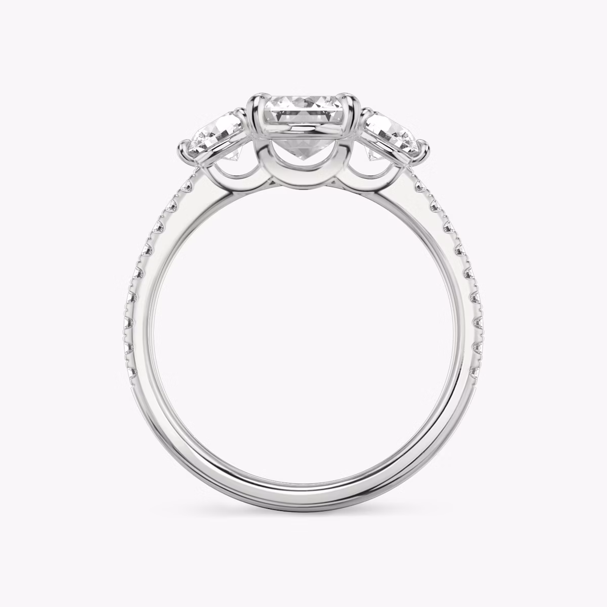 The Three Stone | Emerald | Platinum | bandAccent: Pavé | sideStoneCarat: 0.25ct | sideStoneShape: Round Brilliant | diamondOrientation: vertical | caratWeight: other
