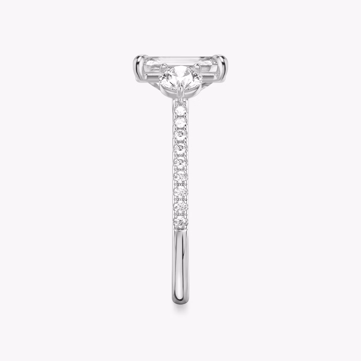 The Three Stone | Emerald | Platinum | bandAccent: Pavé | sideStoneCarat: 0.25ct | sideStoneShape: Round Brilliant | diamondOrientation: vertical | caratWeight: other
