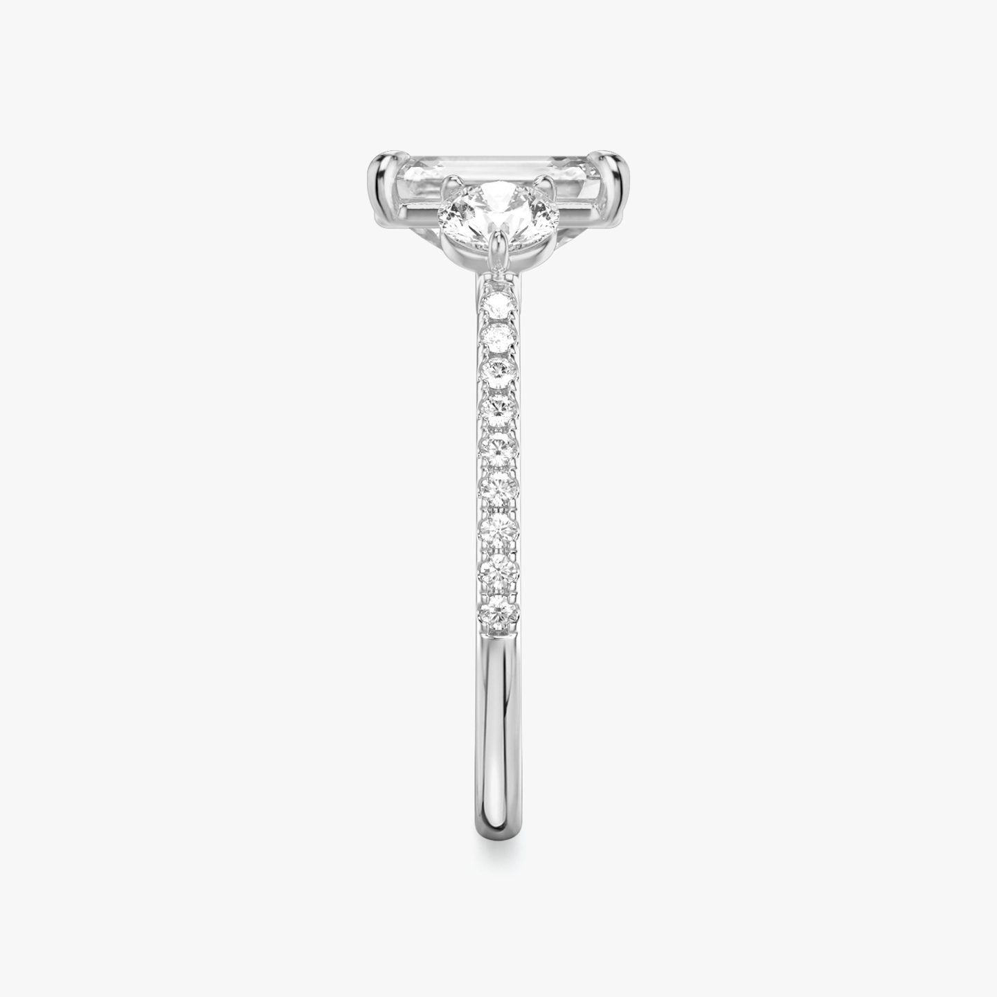 The Three Stone | Emerald | Platinum | bandAccent: Pavé | sideStoneCarat: 0.25ct | sideStoneShape: Round Brilliant | diamondOrientation: vertical | caratWeight: other