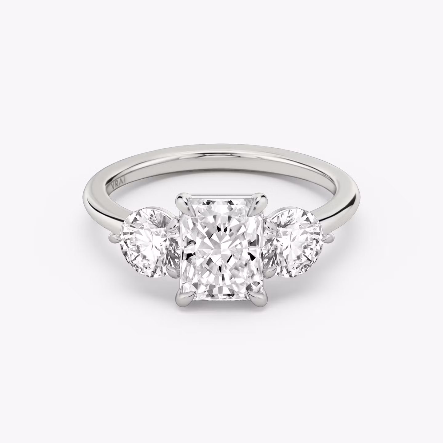 The Three Stone | Radiant | 18k | White Gold | bandAccent: Plain | sideStoneCarat: 0.50ct | sideStoneShape: Round Brilliant | diamondOrientation: vertical | caratWeight: other