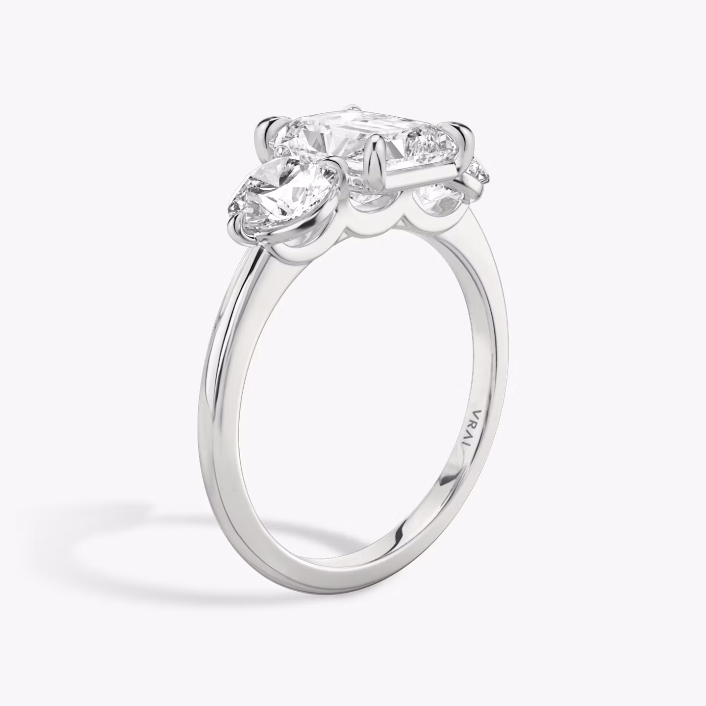 The Three Stone | Radiant | 18k | White Gold | bandAccent: Plain | sideStoneCarat: 0.50ct | sideStoneShape: Round Brilliant | diamondOrientation: vertical | caratWeight: other