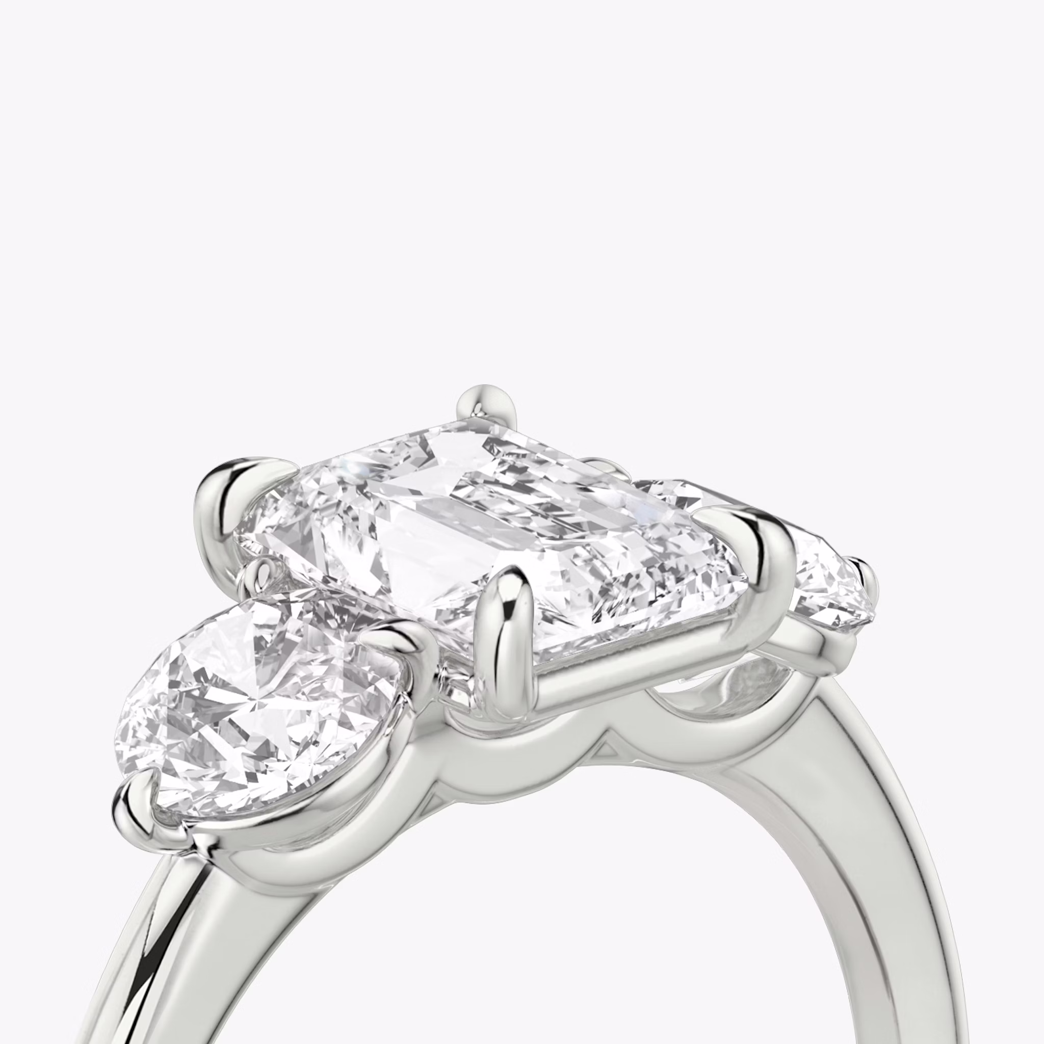 The Three Stone | Radiant | Platinum | bandAccent: Plain | sideStoneCarat: 0.50ct | sideStoneShape: Round Brilliant | diamondOrientation: vertical | caratWeight: other