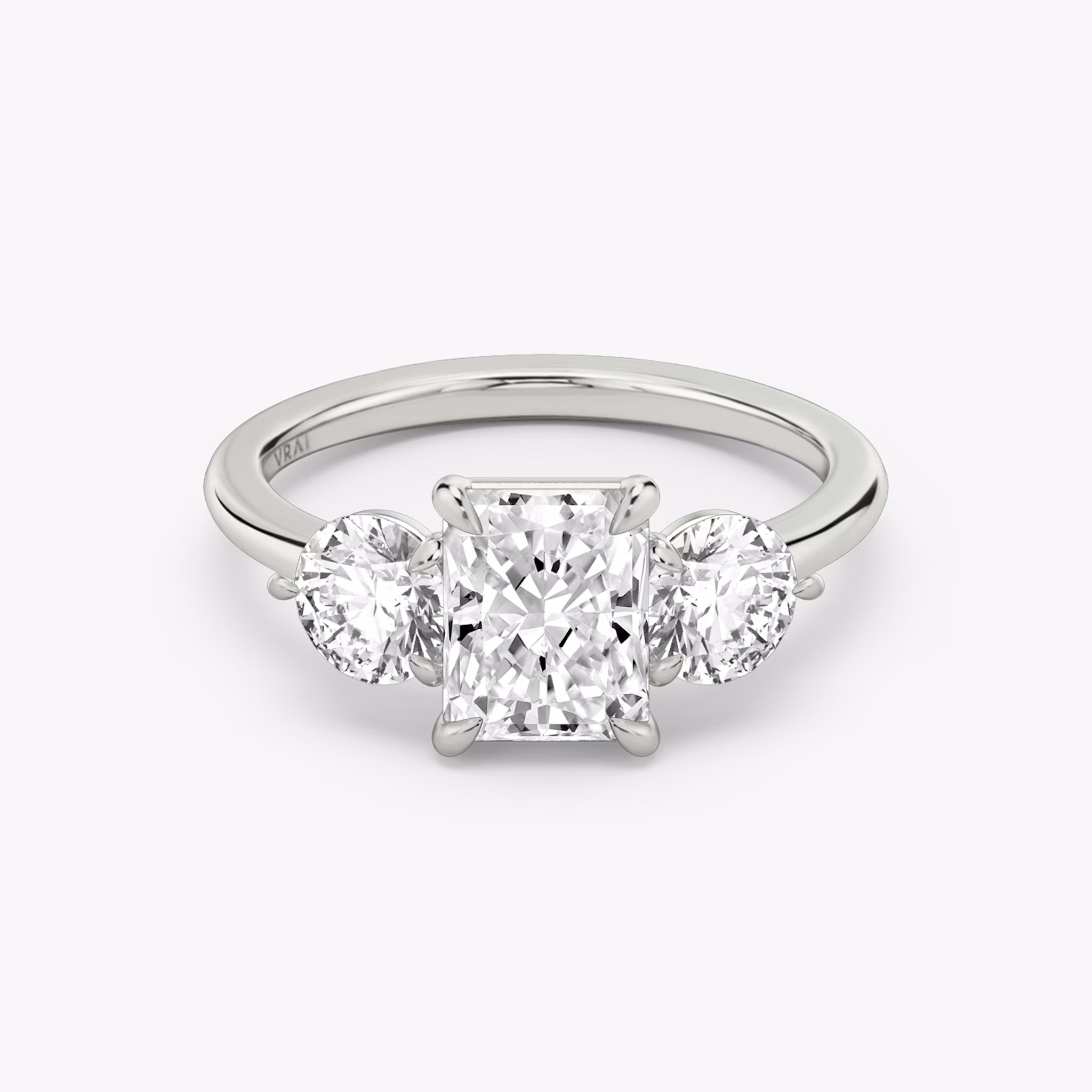 The Three Stone | Radiant | Platinum | bandAccent: Plain | sideStoneCarat: 0.50ct | sideStoneShape: Round Brilliant | diamondOrientation: vertical | caratWeight: other