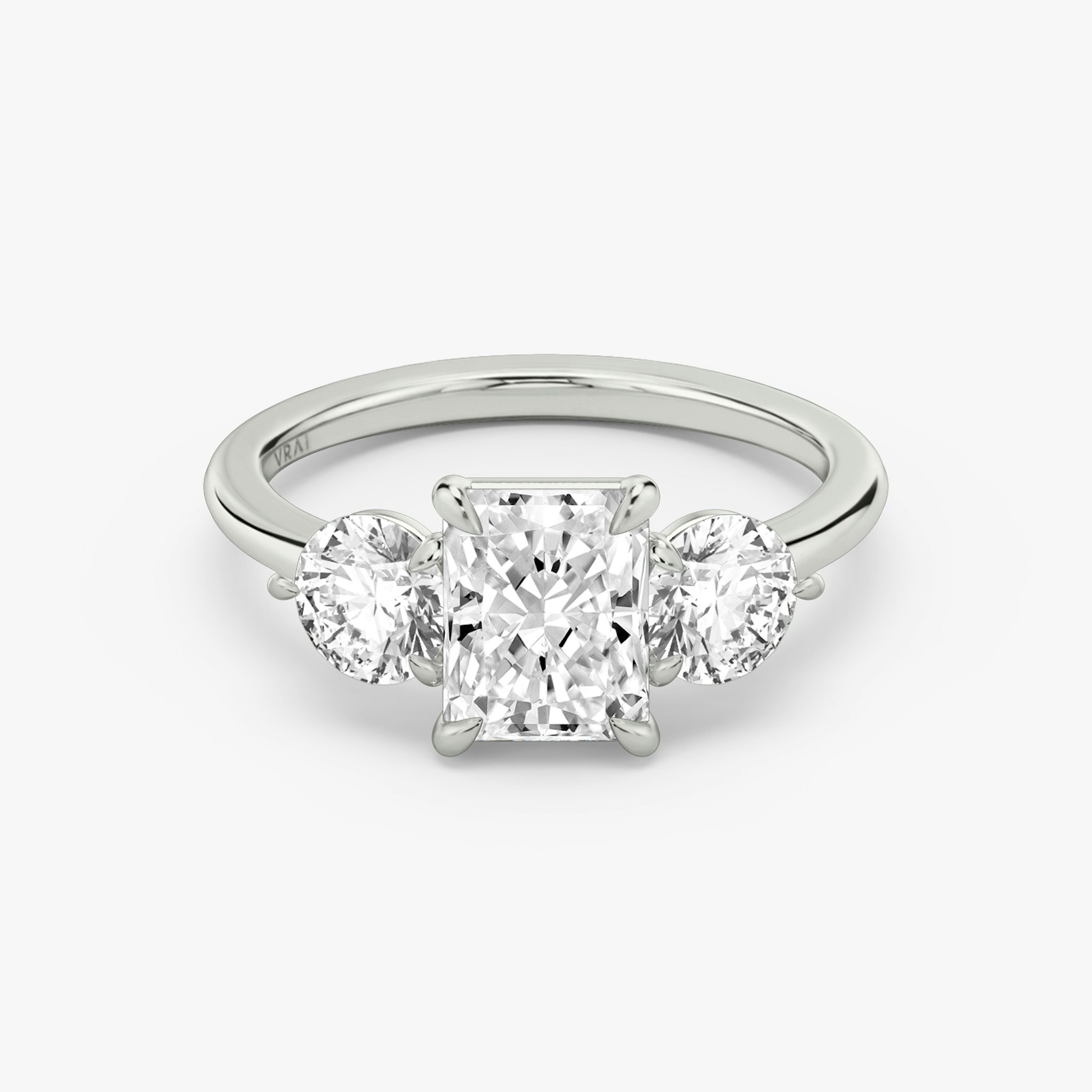 The Three Stone | Radiant | Platinum | bandAccent: Plain | sideStoneCarat: 0.50ct | sideStoneShape: Round Brilliant | diamondOrientation: vertical | caratWeight: other