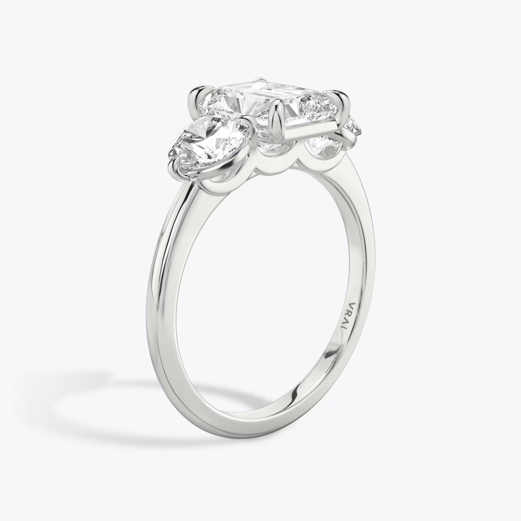 The Three Stone | Radiant | Platinum | bandAccent: Plain | sideStoneCarat: 0.50ct | sideStoneShape: Round Brilliant | diamondOrientation: vertical | caratWeight: other