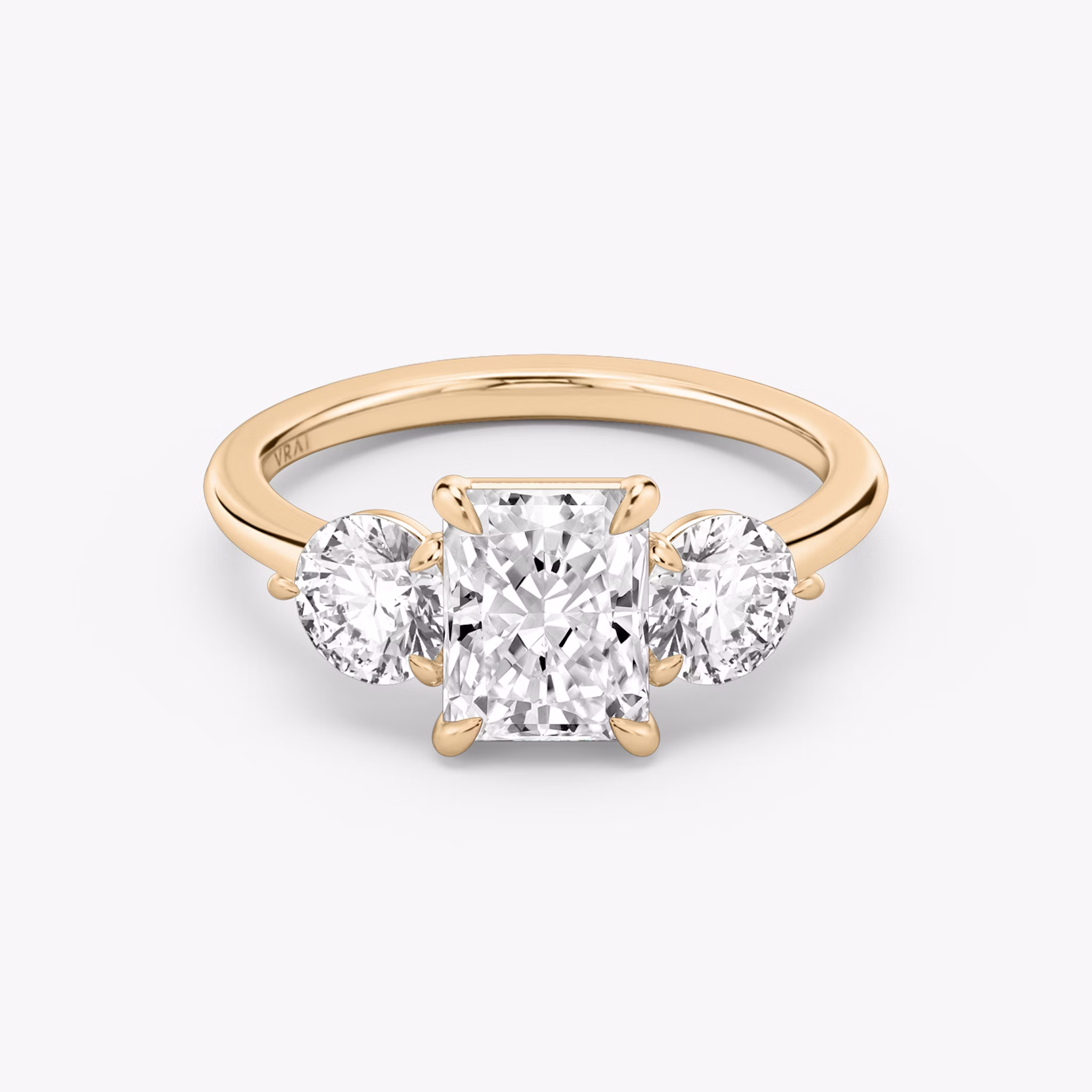 The Three Stone | Radiant | 14k | Rose Gold | bandAccent: Plain | sideStoneCarat: 0.50ct | sideStoneShape: Round Brilliant | diamondOrientation: vertical | caratWeight: other