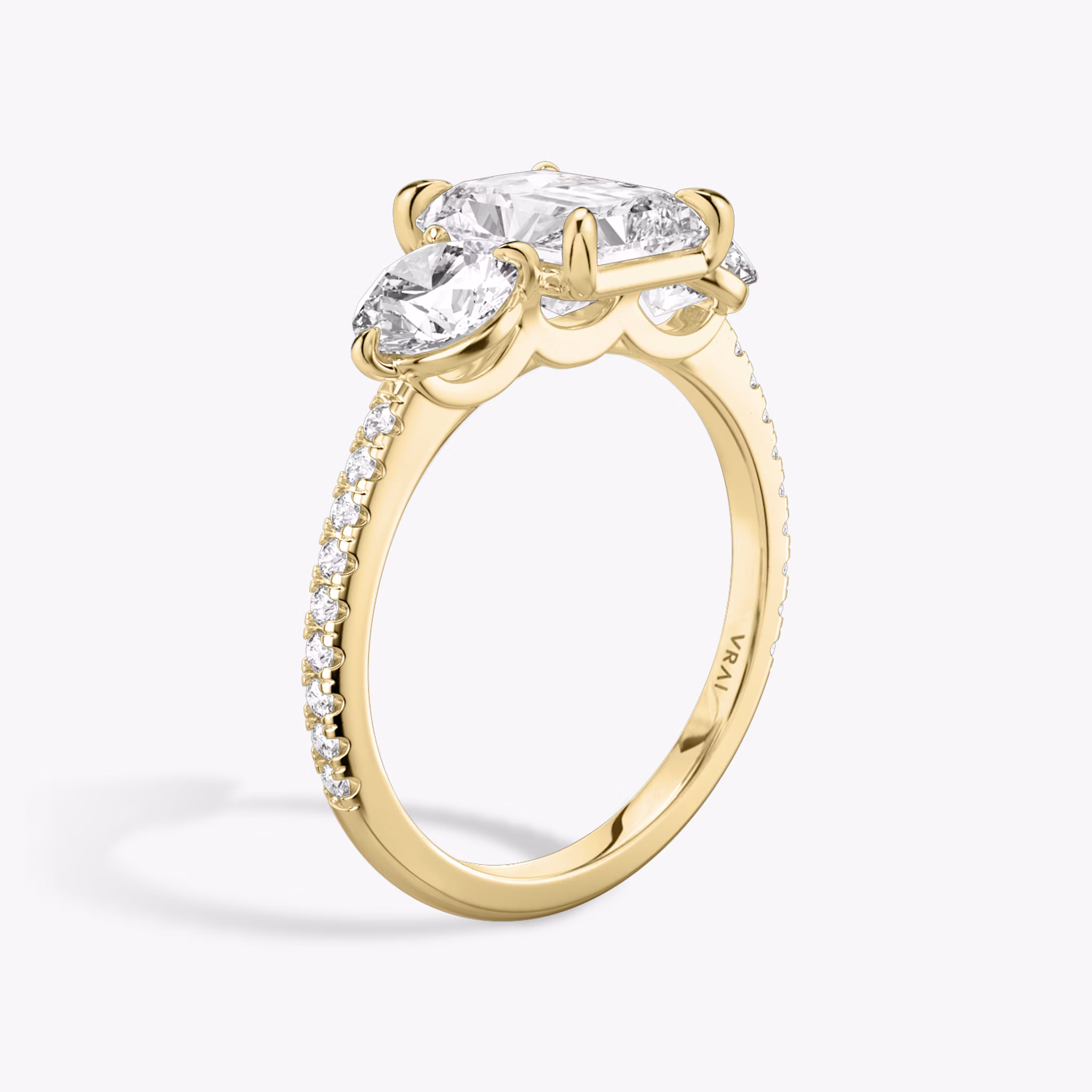 The Three Stone | Radiant | 18k | Yellow Gold | bandAccent: Pavé | sideStoneCarat: 0.50ct | sideStoneShape: Round Brilliant | diamondOrientation: vertical | caratWeight: other