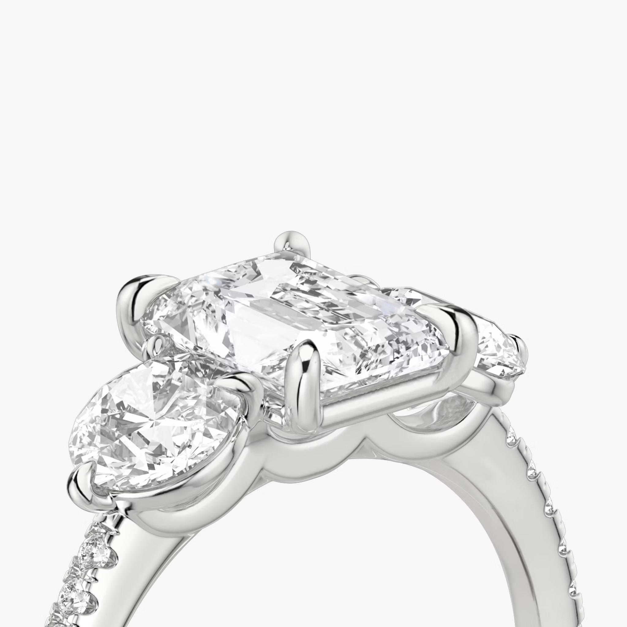 The Three Stone | Radiant | 18k | White Gold | bandAccent: Pavé | sideStoneCarat: 0.50ct | sideStoneShape: Round Brilliant | diamondOrientation: vertical | caratWeight: other