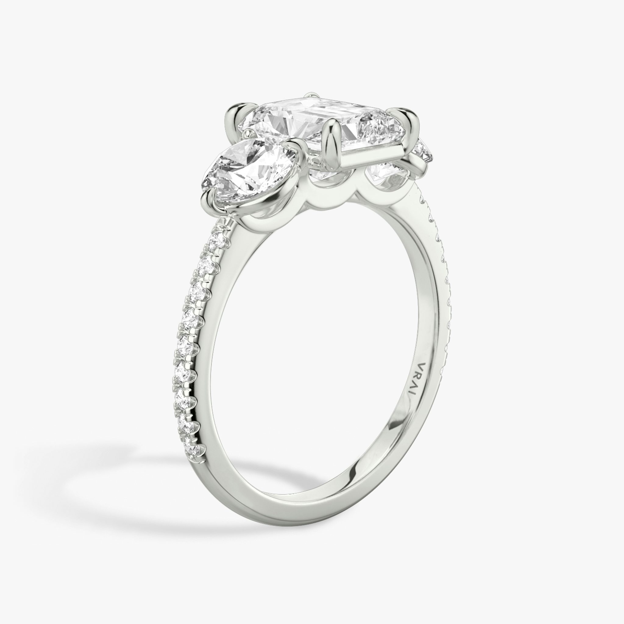 The Three Stone | Radiant | 18k | White Gold | bandAccent: Pavé | sideStoneCarat: 0.50ct | sideStoneShape: Round Brilliant | diamondOrientation: vertical | caratWeight: other
