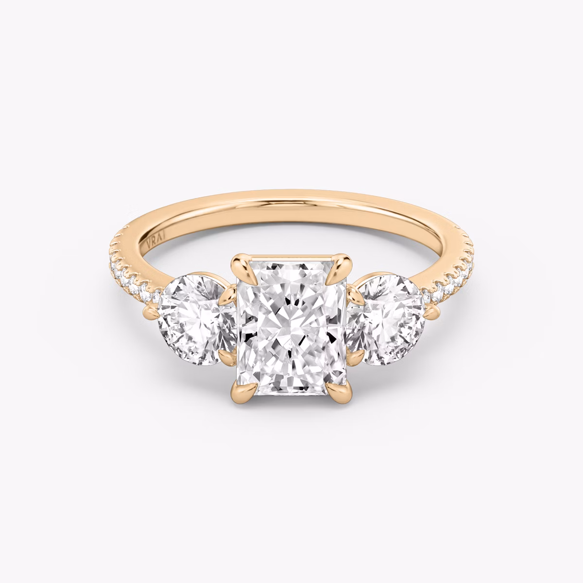 The Three Stone | Radiant | 14k | Rose Gold | bandAccent: Pavé | sideStoneCarat: 0.50ct | sideStoneShape: Round Brilliant | diamondOrientation: vertical | caratWeight: other