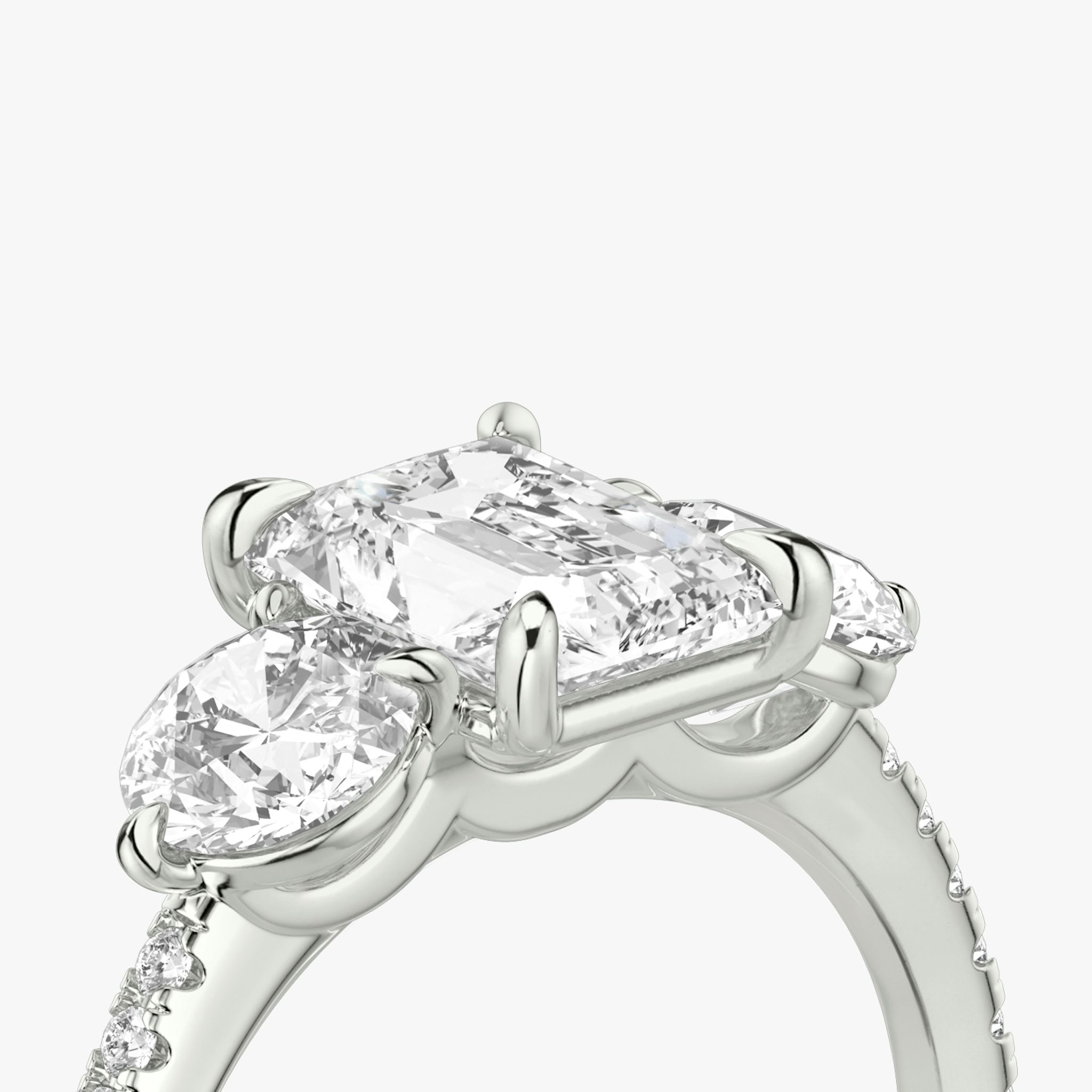 The Three Stone | Radiant | Platinum | bandAccent: Pavé | sideStoneCarat: 0.50ct | sideStoneShape: Round Brilliant | diamondOrientation: vertical | caratWeight: other