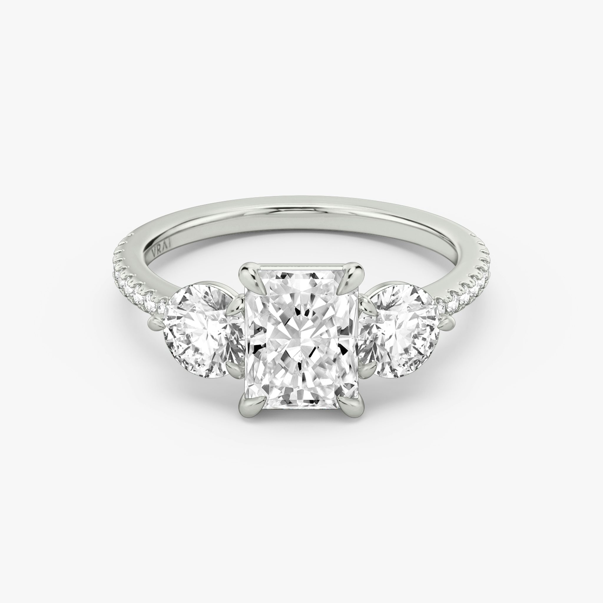 The Three Stone | Radiant | Platinum | bandAccent: Pavé | sideStoneCarat: 0.50ct | sideStoneShape: Round Brilliant | diamondOrientation: vertical | caratWeight: other