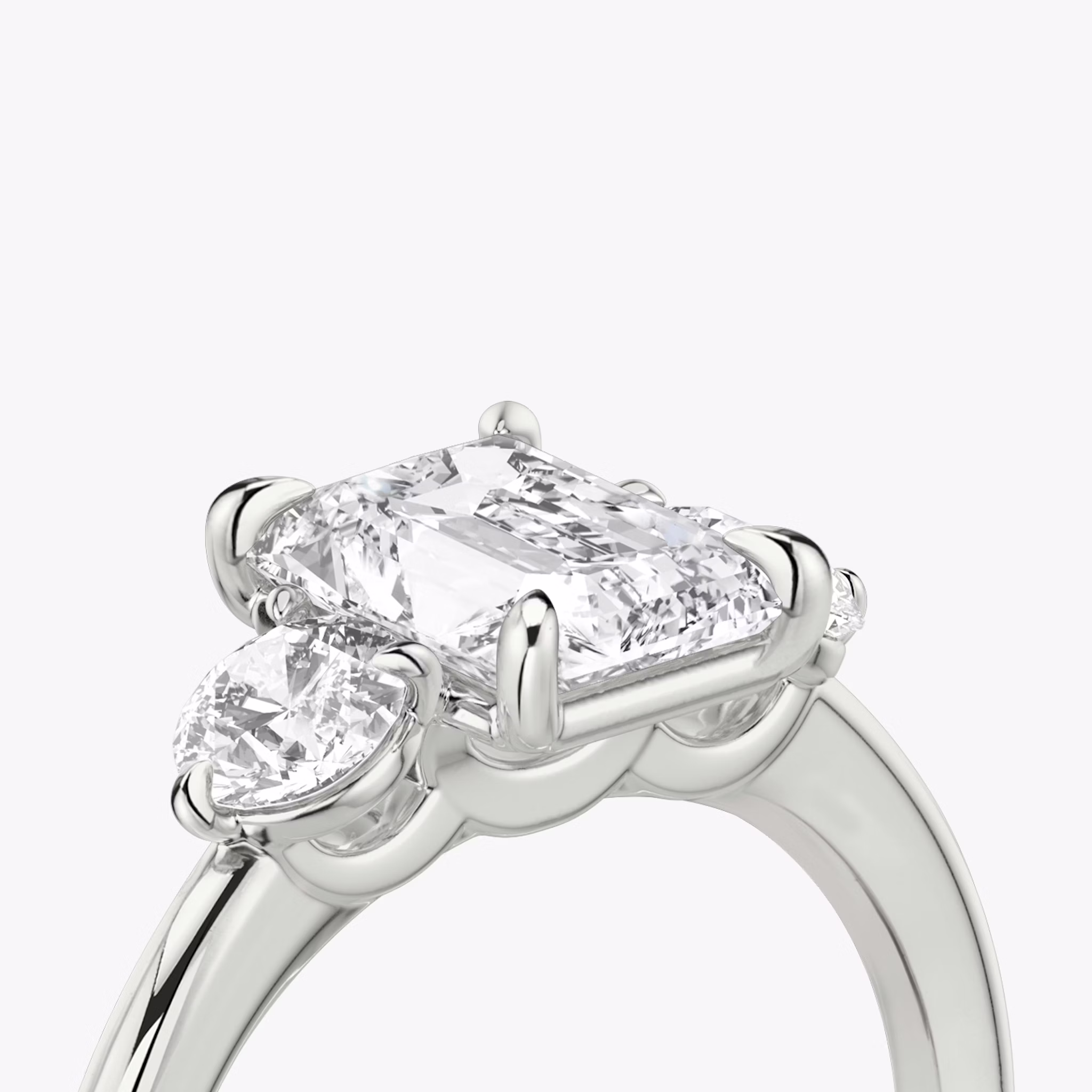 The Three Stone | Radiant | 18k | White Gold | bandAccent: Plain | sideStoneCarat: 0.25ct | sideStoneShape: Round Brilliant | diamondOrientation: vertical | caratWeight: other