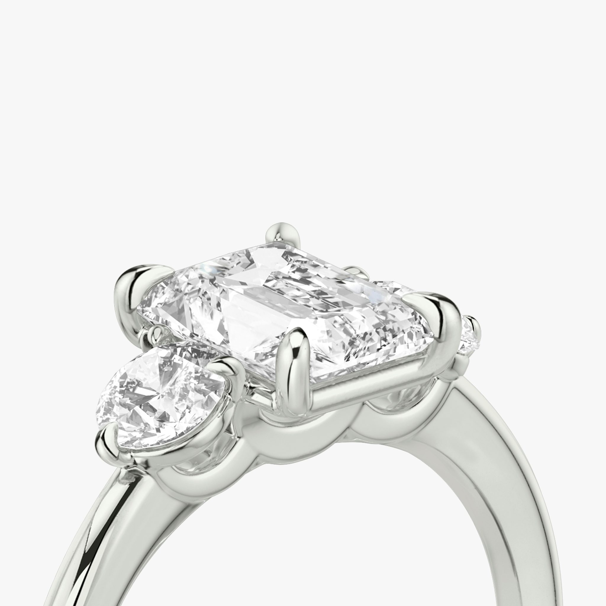 The Three Stone | Radiant | 18k | White Gold | bandAccent: Plain | sideStoneCarat: 0.25ct | sideStoneShape: Round Brilliant | diamondOrientation: vertical | caratWeight: other