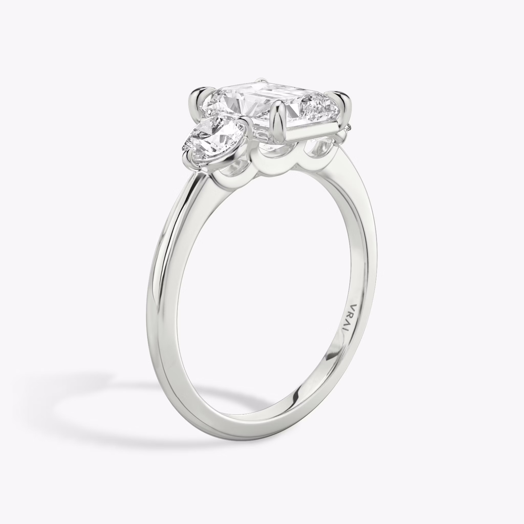 The Three Stone | Radiant | 18k | White Gold | bandAccent: Plain | sideStoneCarat: 0.25ct | sideStoneShape: Round Brilliant | diamondOrientation: vertical | caratWeight: other