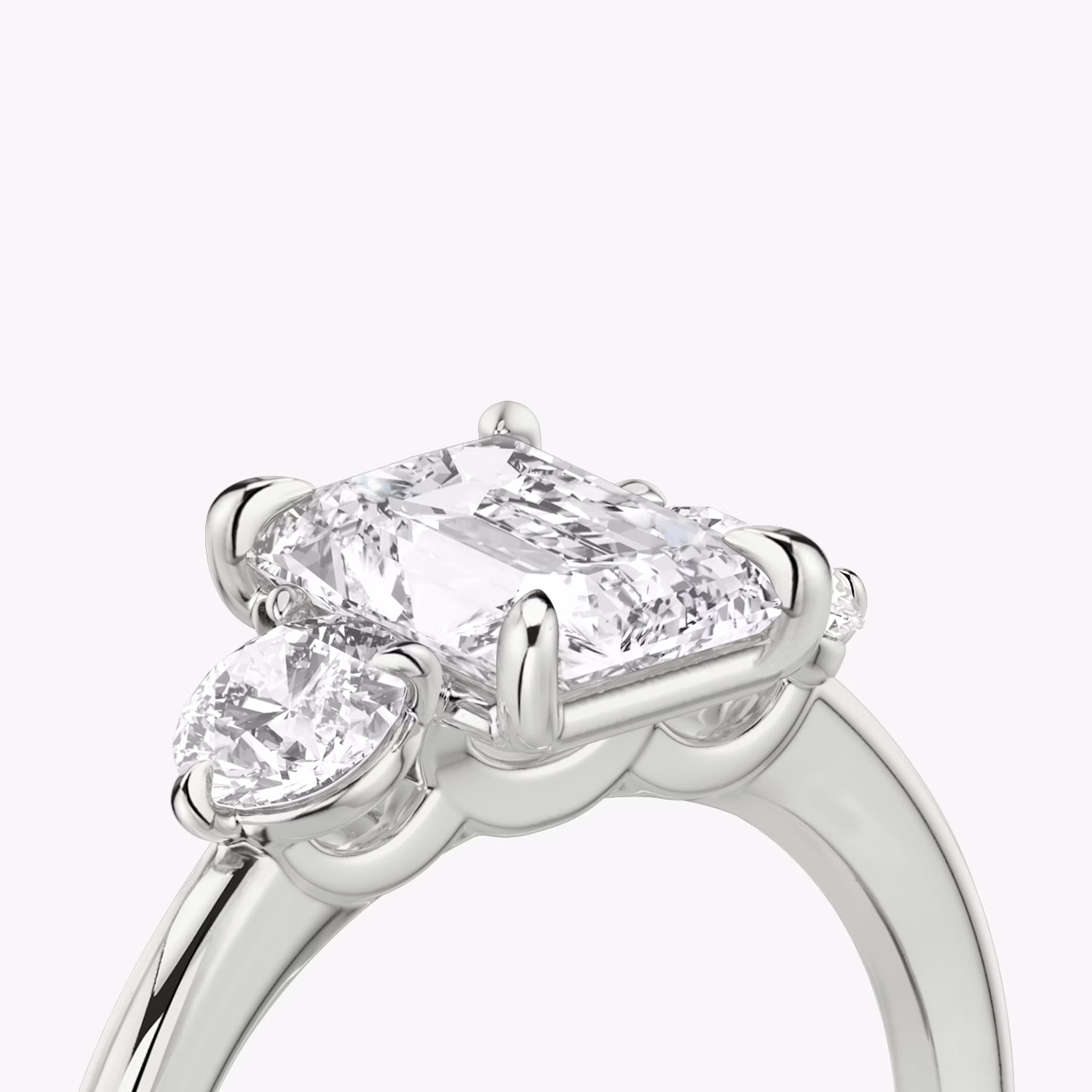 The Three Stone | Radiant | Platinum | bandAccent: Plain | sideStoneCarat: 0.25ct | sideStoneShape: Round Brilliant | diamondOrientation: vertical | caratWeight: other