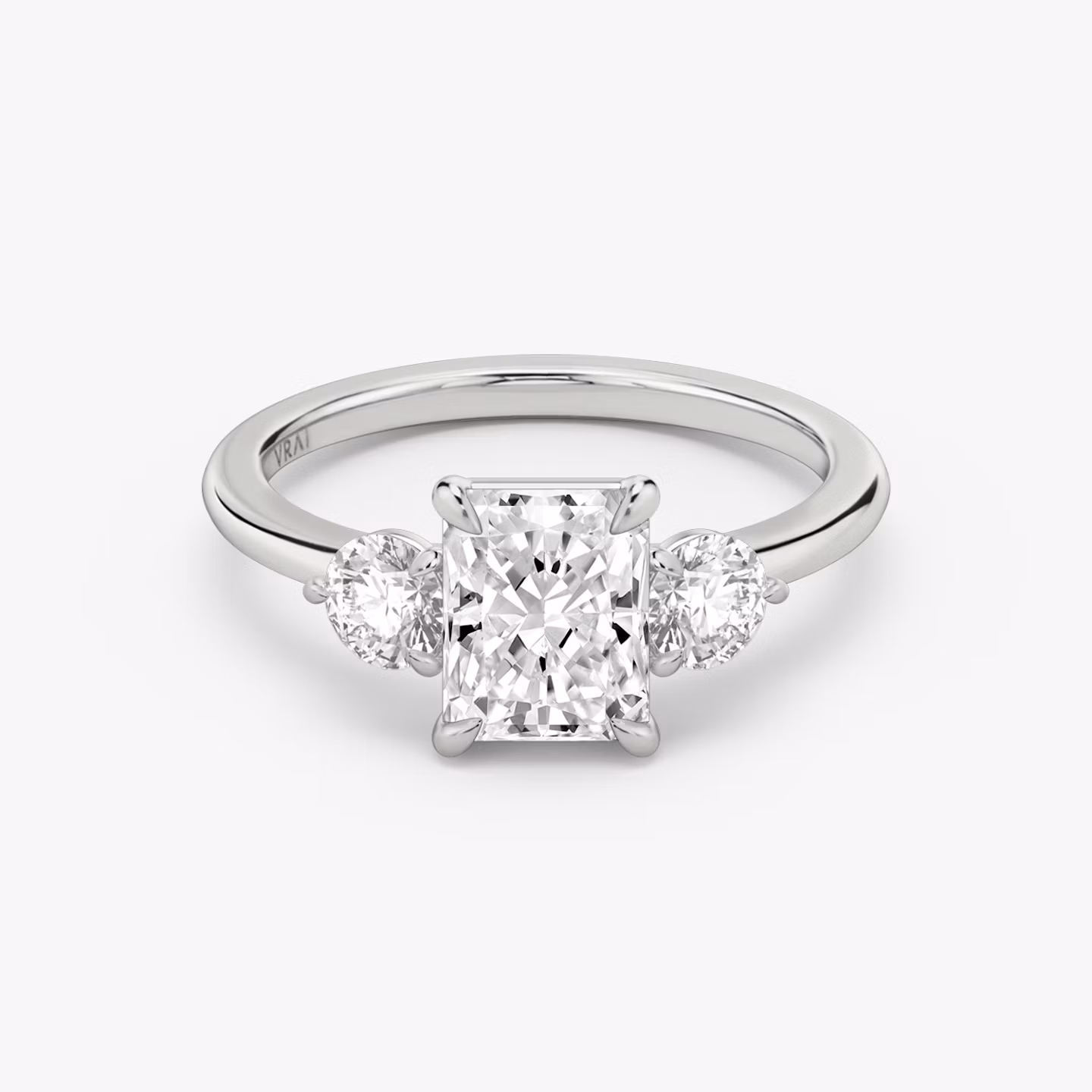 The Three Stone | Radiant | Platinum | bandAccent: Plain | sideStoneCarat: 0.25ct | sideStoneShape: Round Brilliant | diamondOrientation: vertical | caratWeight: other
