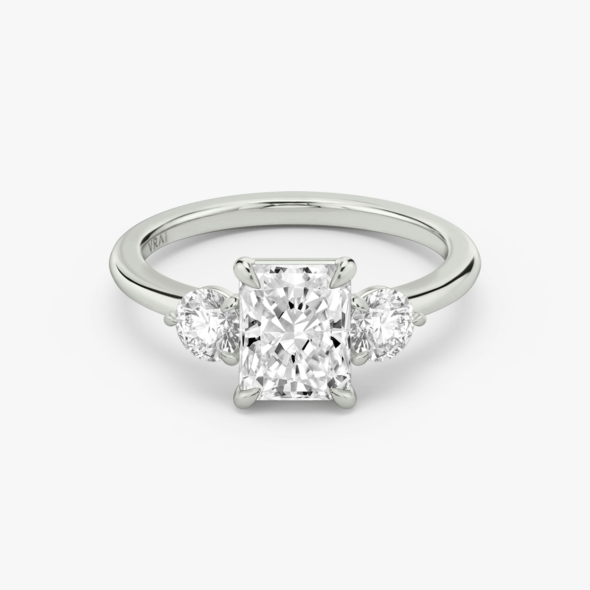 The Three Stone | Radiant | Platinum | bandAccent: Plain | sideStoneCarat: 0.25ct | sideStoneShape: Round Brilliant | diamondOrientation: vertical | caratWeight: other